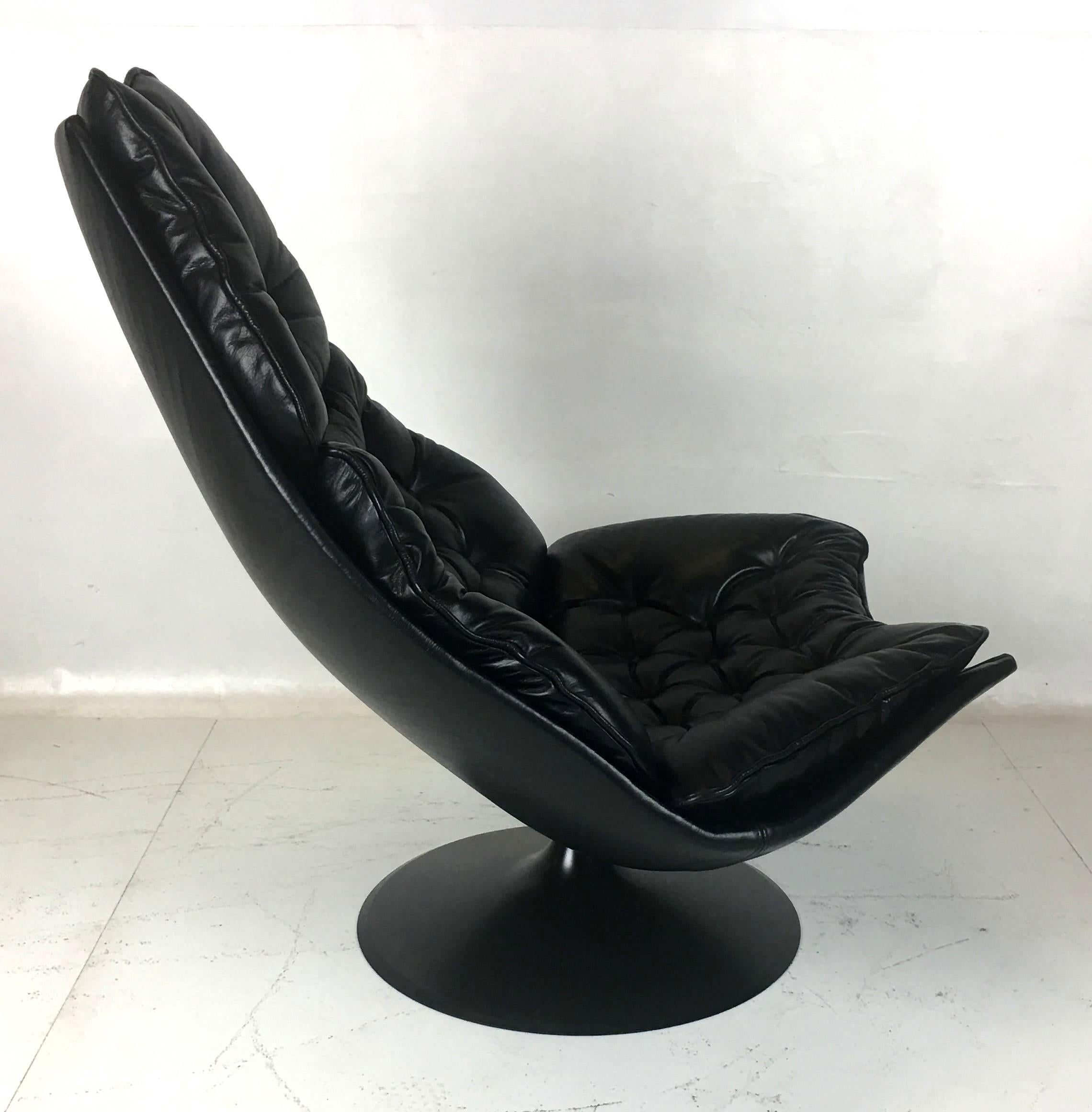 Painstakingly restored swivel lounge chair by Geoffrey Harcourt for Artifort. No expense was spared in the restoration of this Classic chair. It is freshly upholstered in black leather and the base has been refinished in Polyurethane lacquer.  All