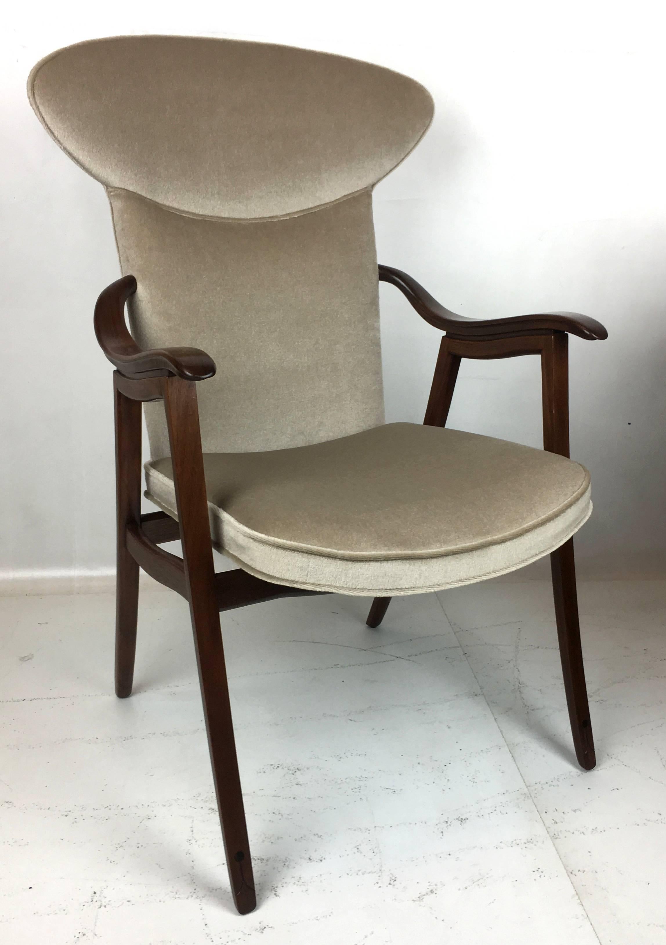 
This beautifully crafted set of four wingback Walnut Dining chairs was custom made for the Executive offices of Owens-Corning, attributed to Edward Wormley for Dunbar Furniture Co.. The chairs and their construction, materials hardware, and