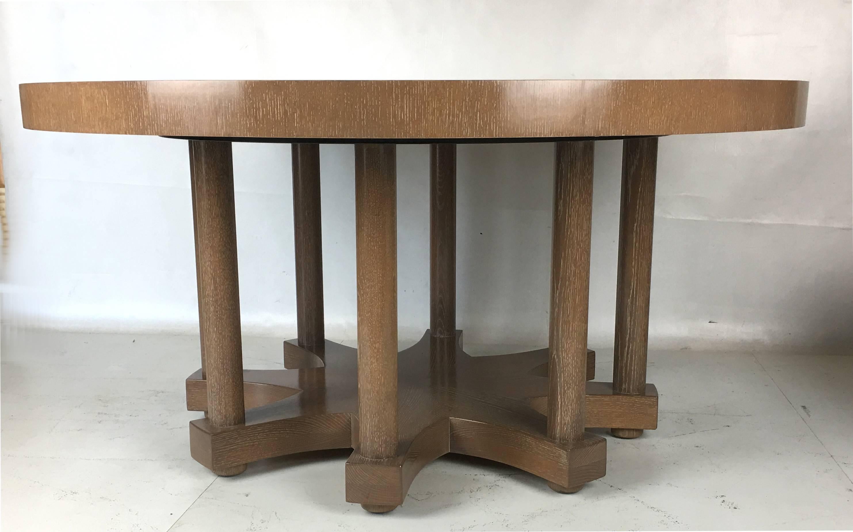 Fantastic and large-scale designer dining table with a solid oak base. The starburst veneered top is raised on solid oak columns on an eight point star base. The table has been refinished in a beautiful hand rubbed cerused finish.