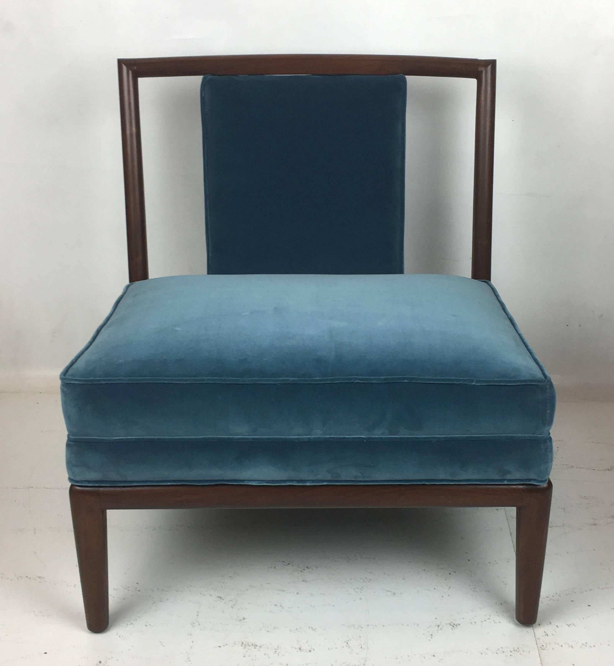 Lovely pair of exposed walnut frame slipper chairs in the style of Robsjohn-Gibbings. The pair have been meticulously restored and refinished, and reupholstered in elegant heavyweight teal velvet.  
