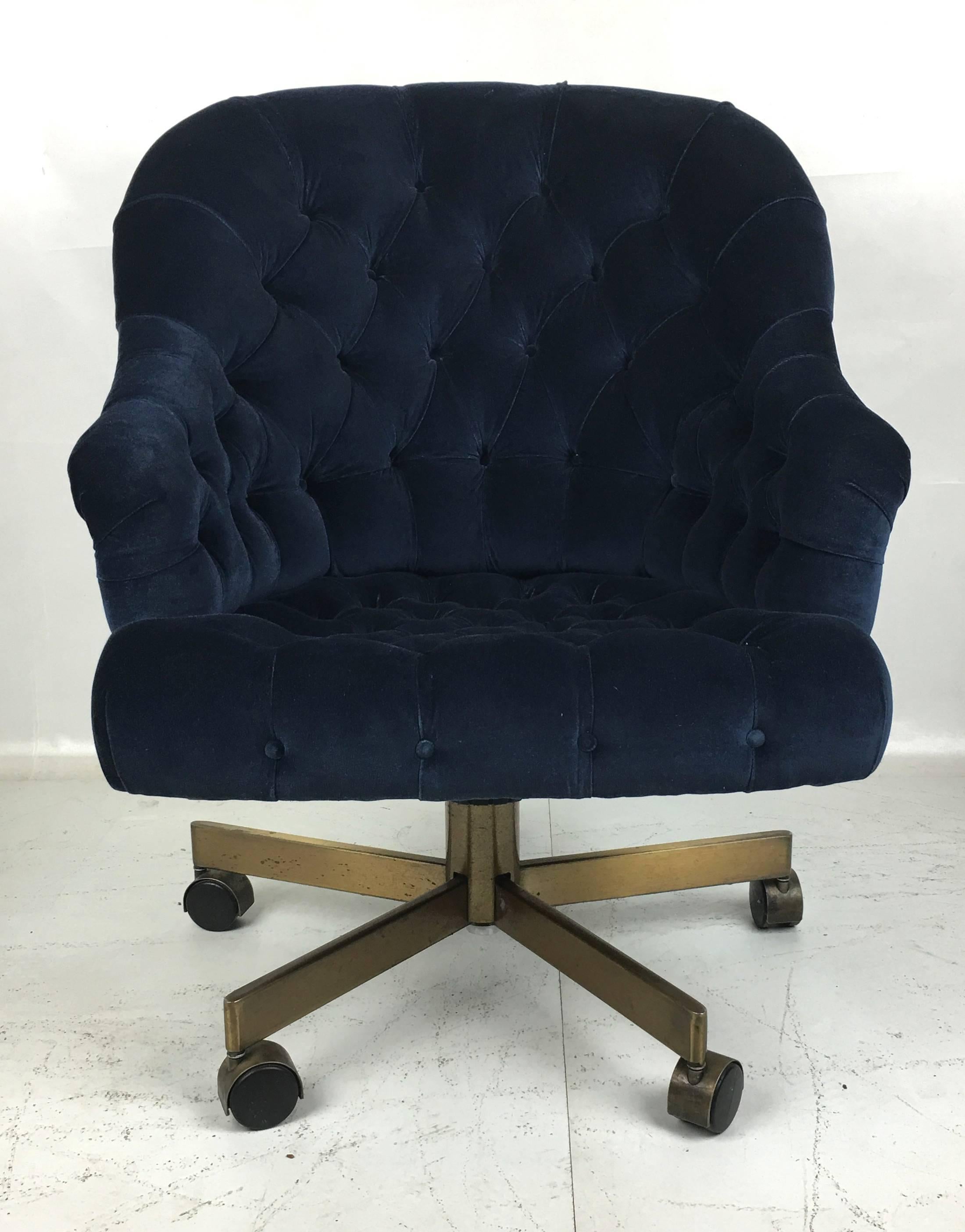 Classic Dunbar executive swivel chair freshly upholstered in luxurious Navy velvet . The chair is fully adjustable and super comfortable. Raised on a bronze-plated steel base with bronze hooded casters.  