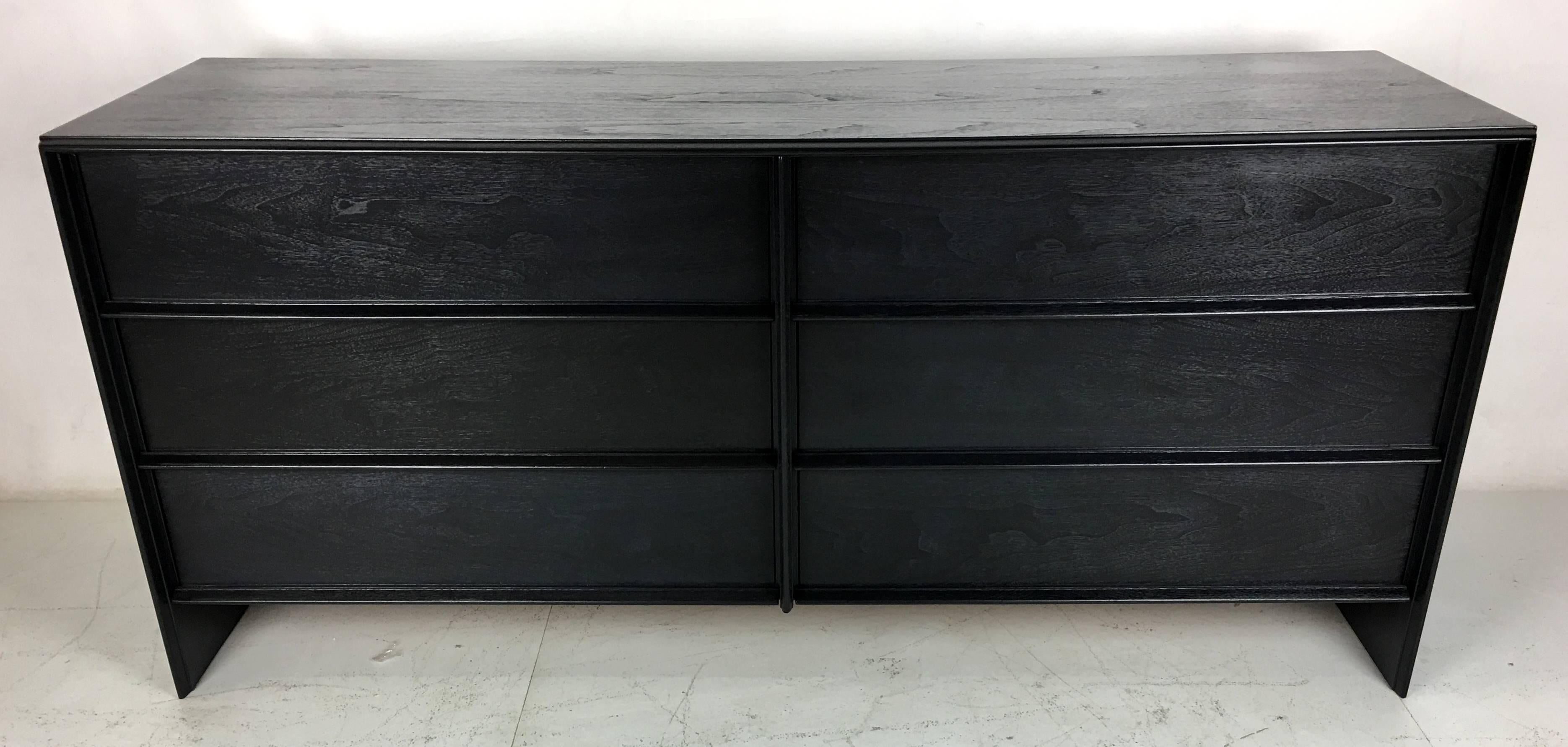 A beautiful example of this classic Modern Thinline Dresser by T.H. Robsjohn-Gibbings for Widdicomb refinished in a deep charcoal grey lacquer. We've worked on this color for a long time and we finally got it just right. It's a chic update for this