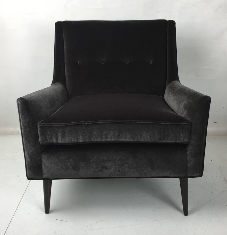 Handsome lounge chair in the style of Paul McCobb. The chair has been painstakingly restored from the ground up with new foam/Dacron and reupholstered in luxurious heavyweight charcoal grey velvet. The legs have been refinished in dark brown lacquer.