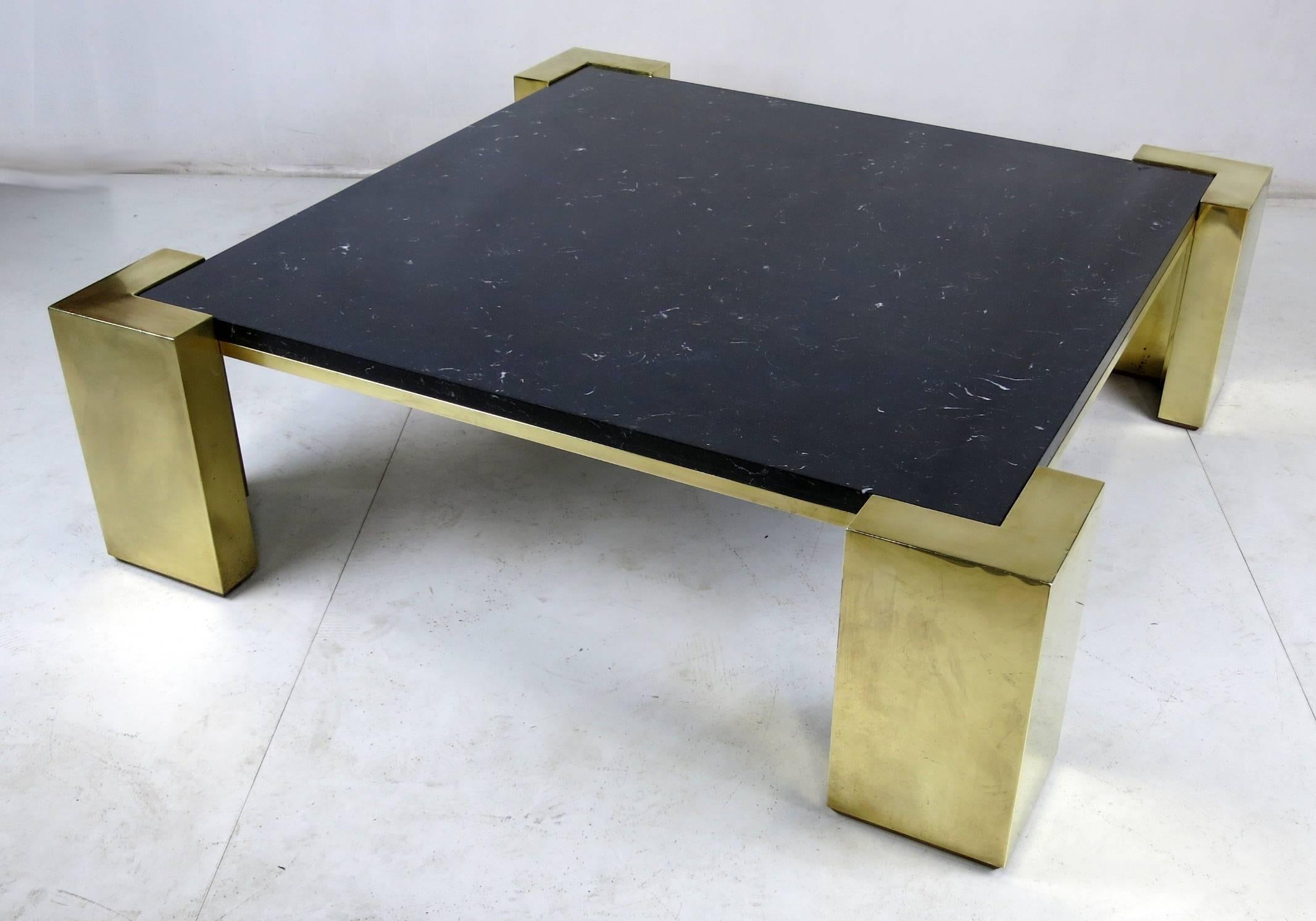 Large and dramatic scale coffee table with brass corners and frame with inset black marble top similar in style to those by Karl Springer.  Top quality materials and workmanship.  