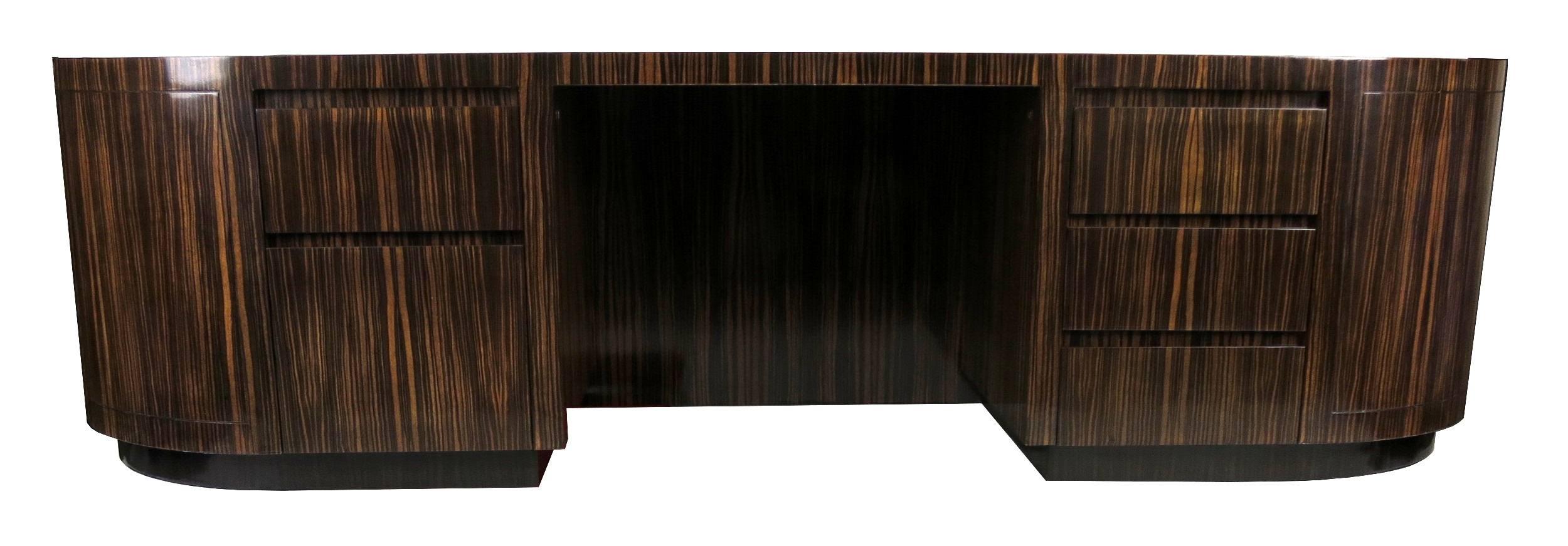 Spectacular and large-scale Custom Executive Desk in Macassar ebony, raised on a rosewood plinth base by Leon Rosen for Pace. The desk has five drawers and a three-piece inset leather top. The desk has been meticulously restored and refinished in