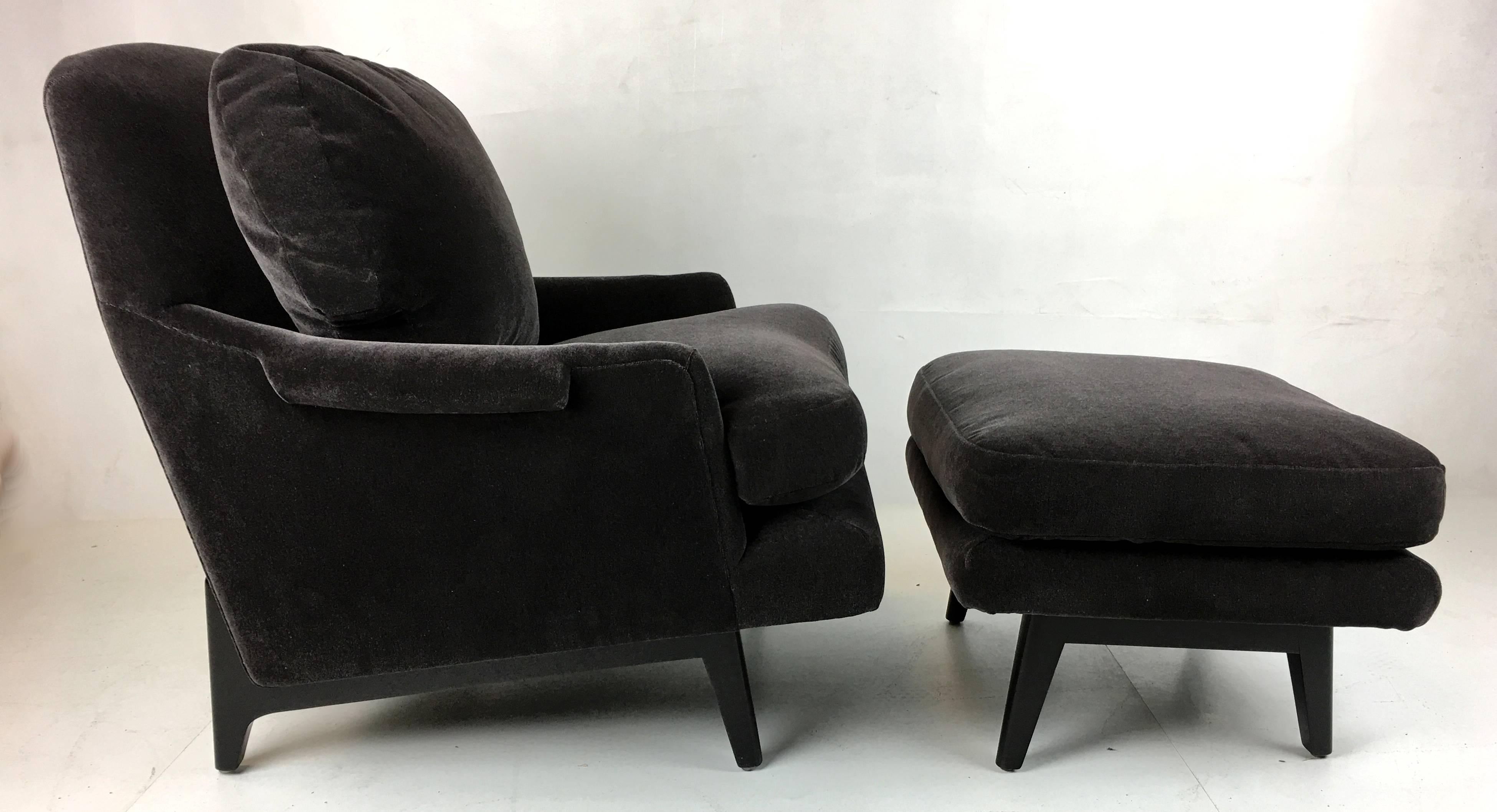 Handsome modern lounge chair and ottoman with exposed mahogany base by Dunbar. This chair has perfect ergonomics and is as comfortable as can be....lounge on.