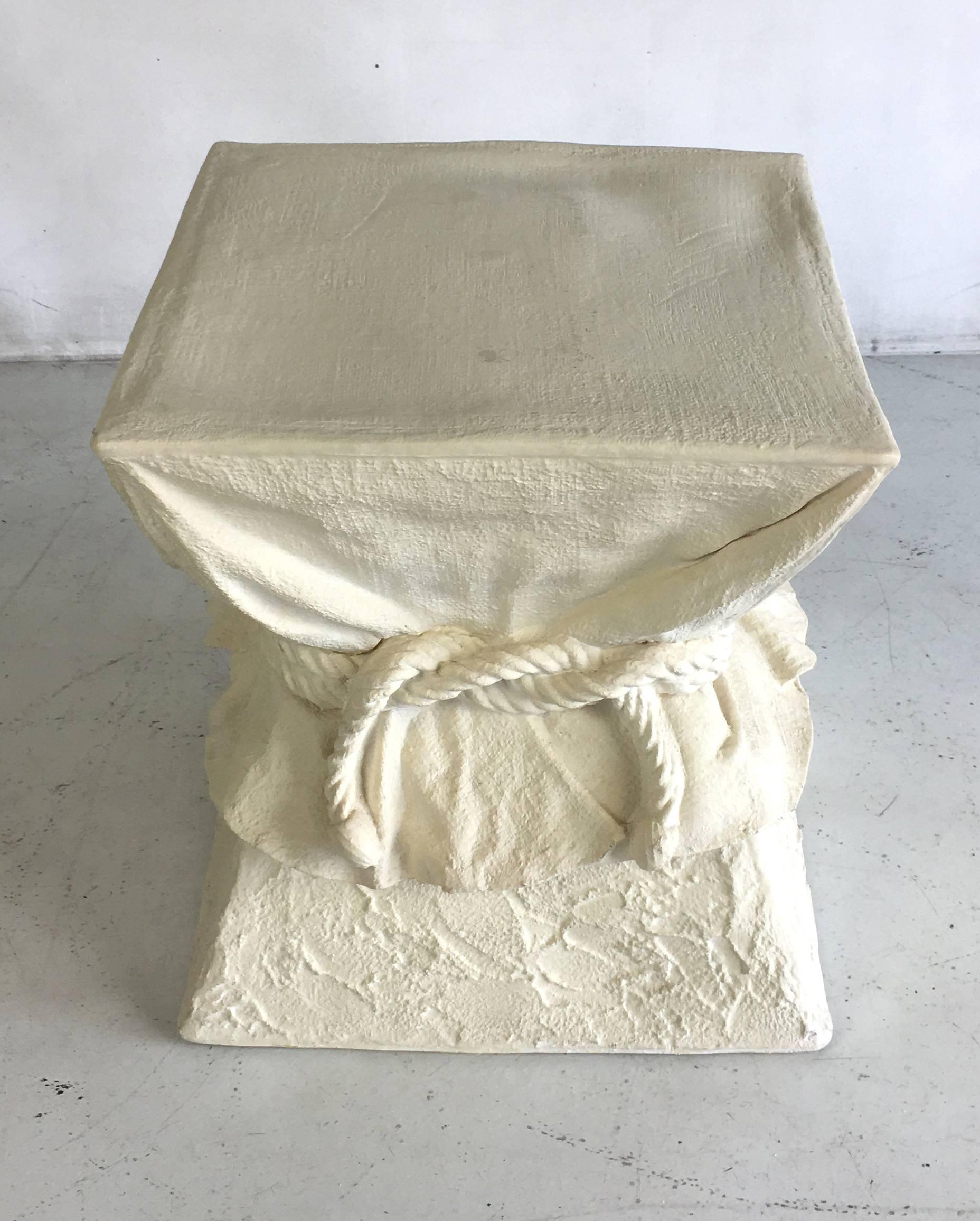 Mid-Century table depicting a square hourglass form table draped with cloth and bound with rope. The form is finished in white Gesso. We have another similar item of different dimensions: 12 x 12 x 21.5.