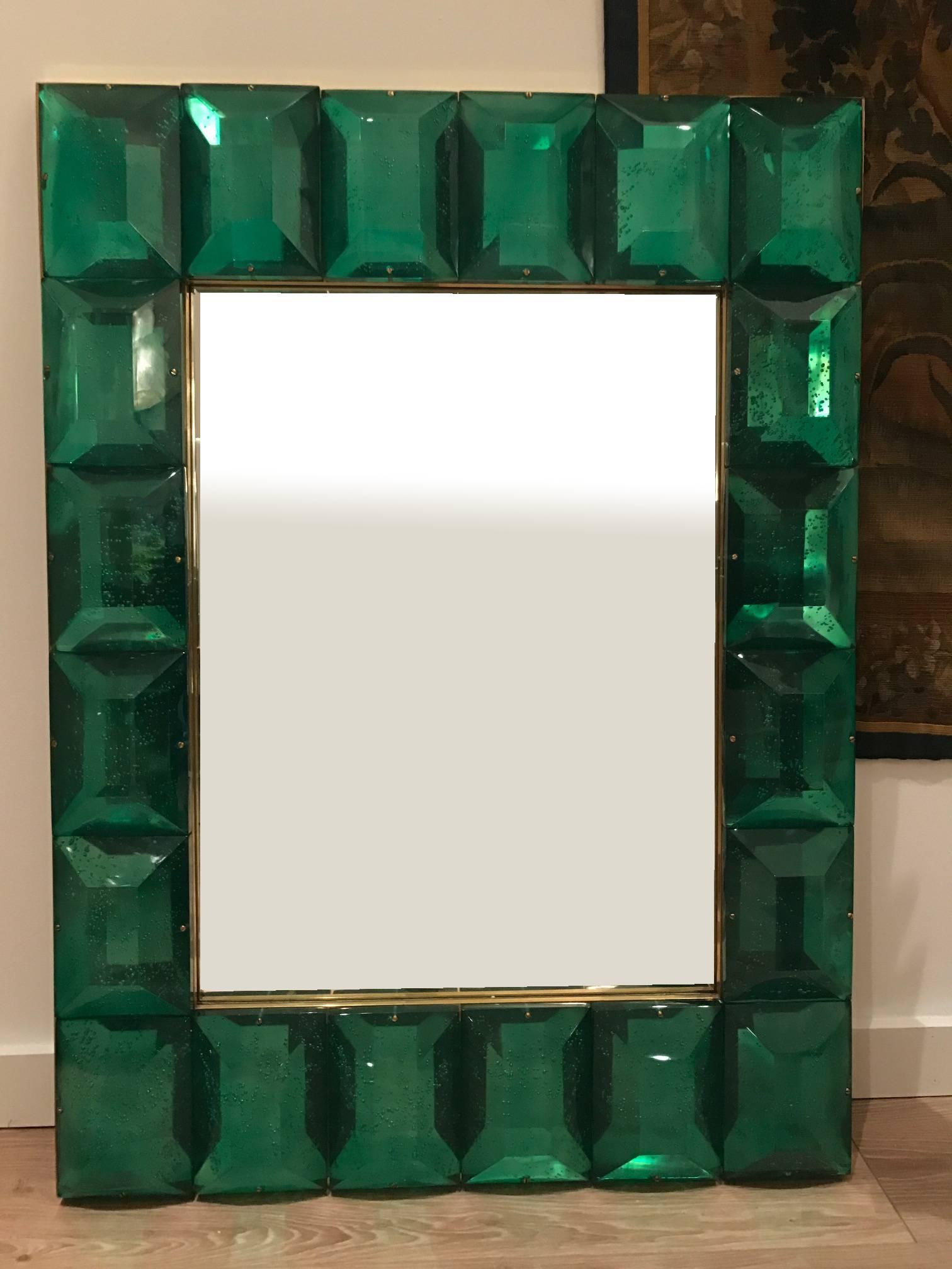  Customizable Faceted Murano Glass Mirror in Emerald Green
Contemporary and customizable mirror with a faceted Murano glass frame, edged in brass and handcrafted by a team of artisans in Venice, Italy. Each emerald green glass block has a highly