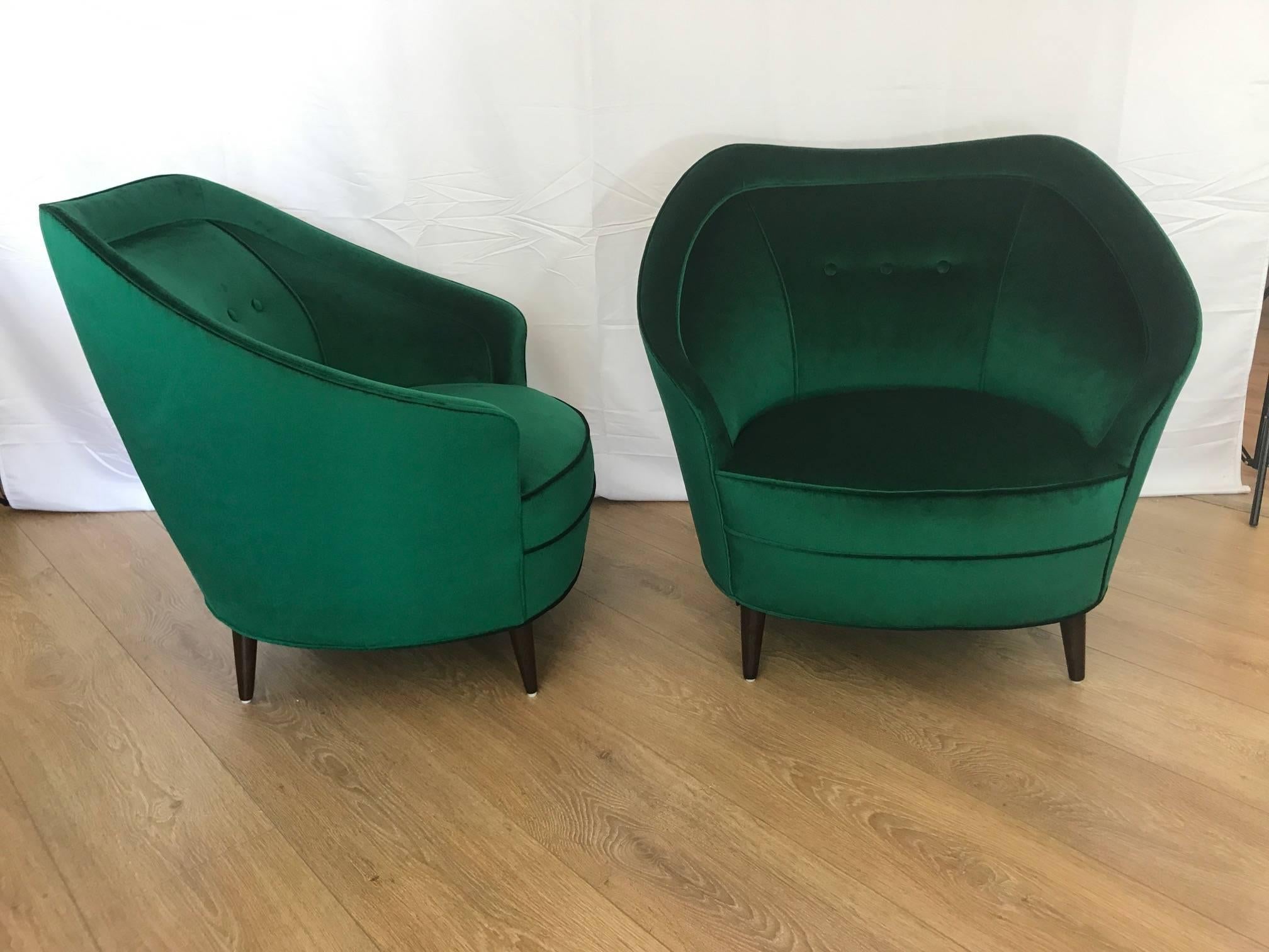 Pair of Italian mid century lounge chairs.  Newly upholstered with Lafayette green velvet, wooden conical legs.