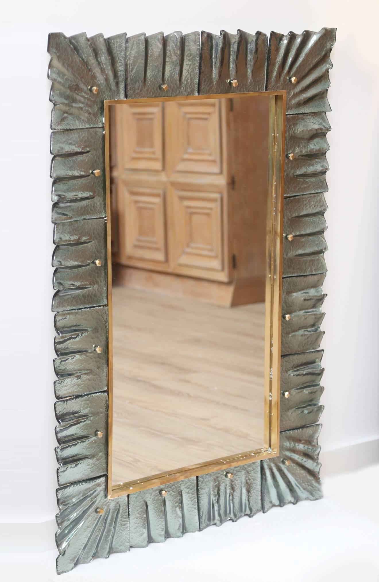 Modern aqua green Murano glass and brass decorative mirror with solid brass cabochon accents. Glass texture and color are absolutely striking. Pair is available. Priced per item. Can be hung vertical or horizontal.