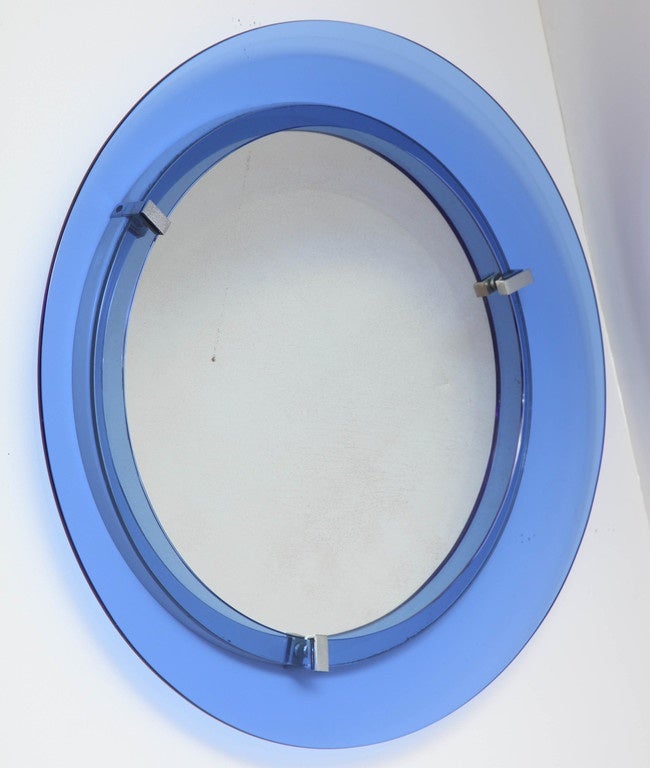 1950s round glass mirror with a blue transparent glass frame, chrome accents by Cristal Art, Italy.

This item is located in Manhattan at 1stdibs@nydc showroom.
200 Lexington Ave - 10th floor, NYC.