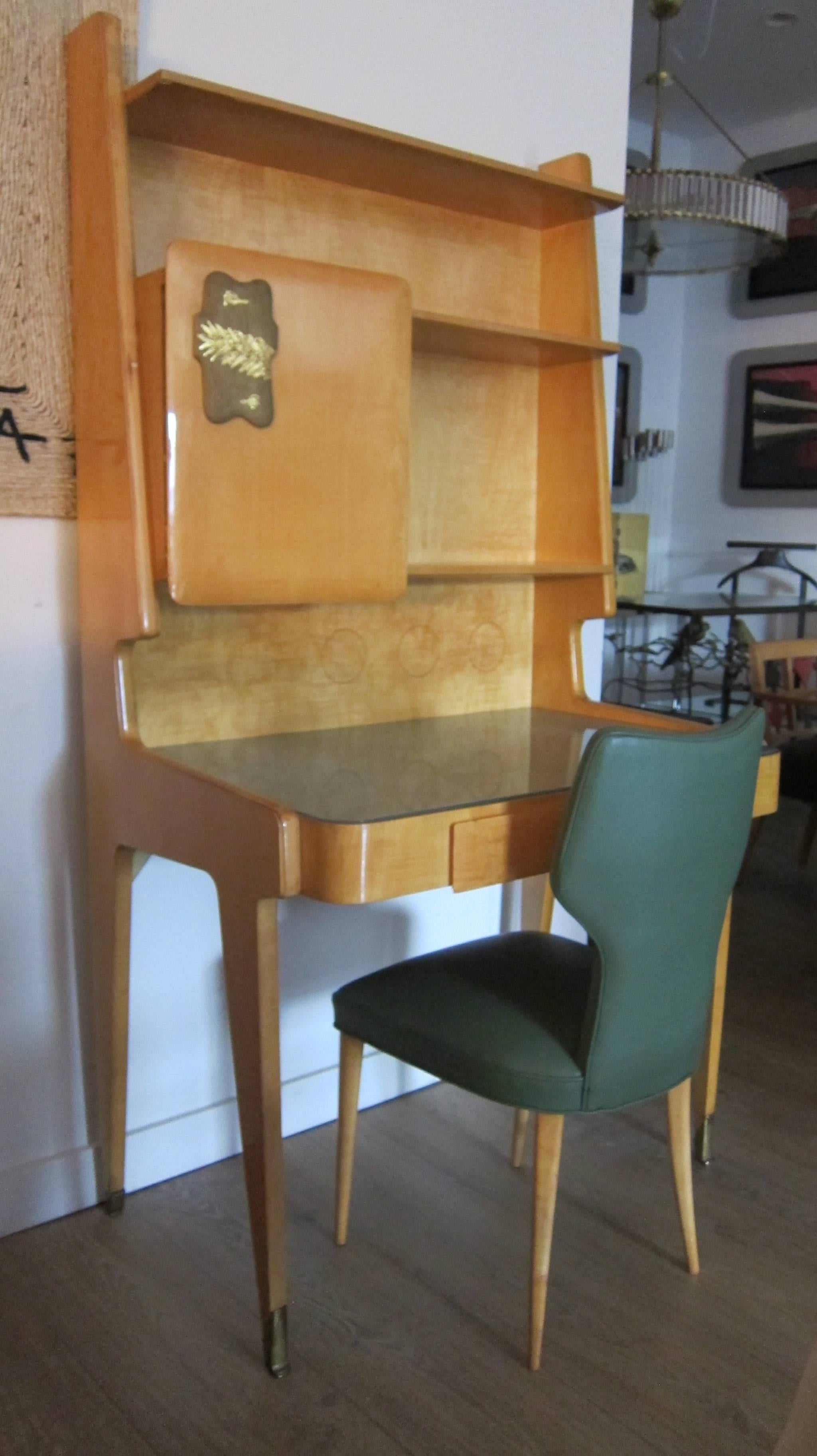 A rare Italian 1950s , writing desk or secretary in the style of Gio Ponti. All pear wood veneer with light green inset glass top, solid brass sabots, comes with the original matching chair (newly upholstered with green leather). Original patina.