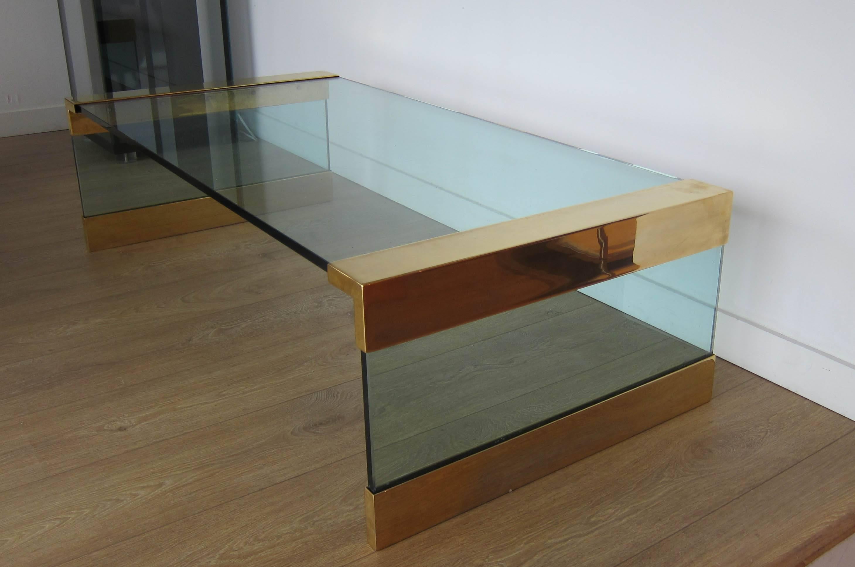 Very chic and elegant Pace coffee table. Thick subtle green tone glass and brass plated steel fittings.
 

