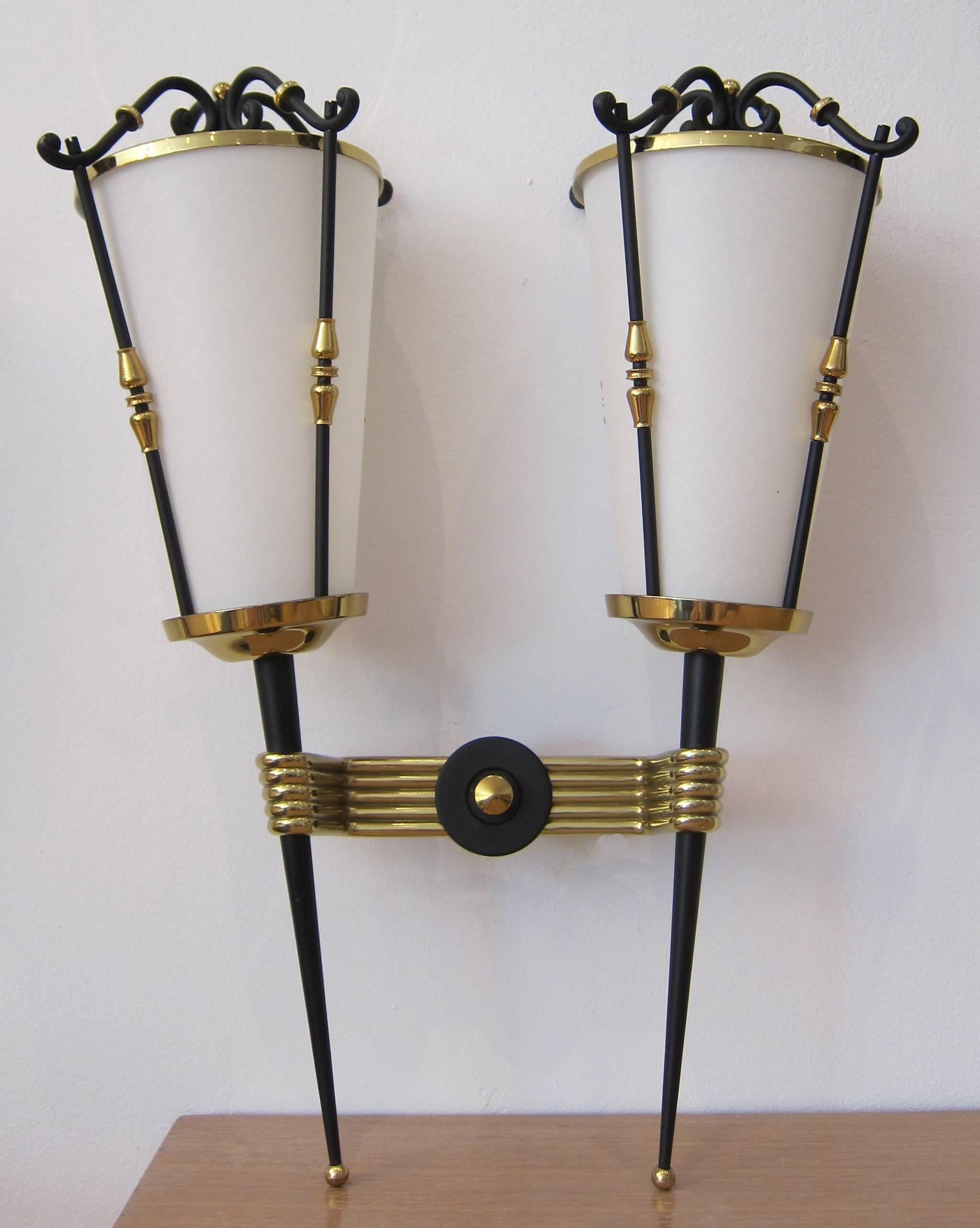Pair of double arm lantern wall sconces. Brass and black painted metal with perforated tops. Completely redone to perfection including new parchment shades.