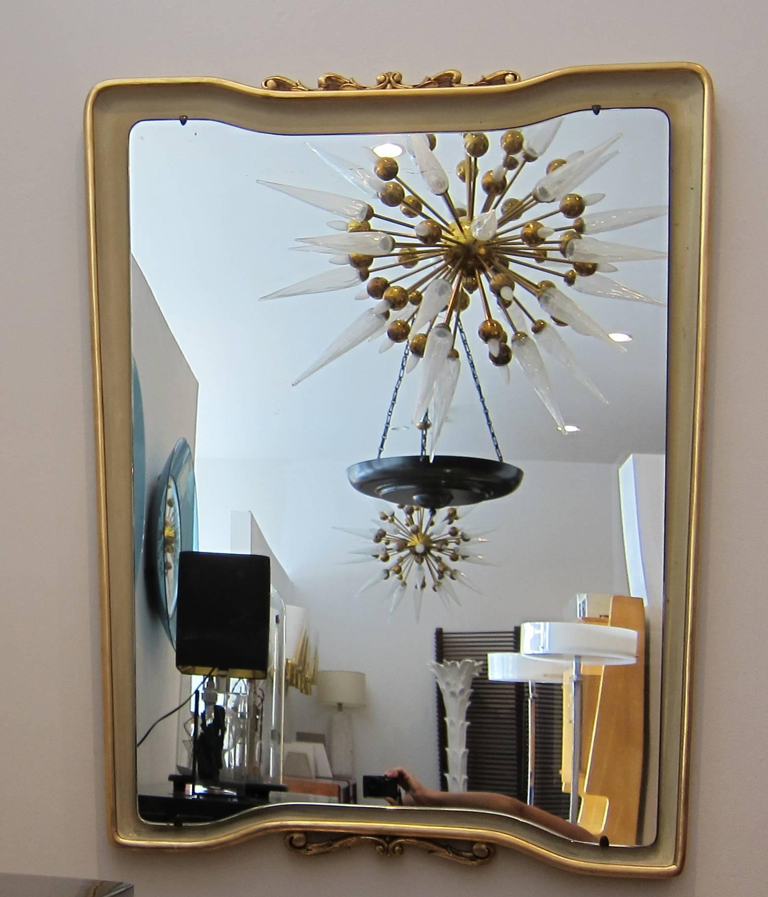 Italian 1950s large parcel gilt wood frame mirror by Osvaldo Borsani.
Excellent original condition with minor wear consistent with age and use preserving a beautiful patina.