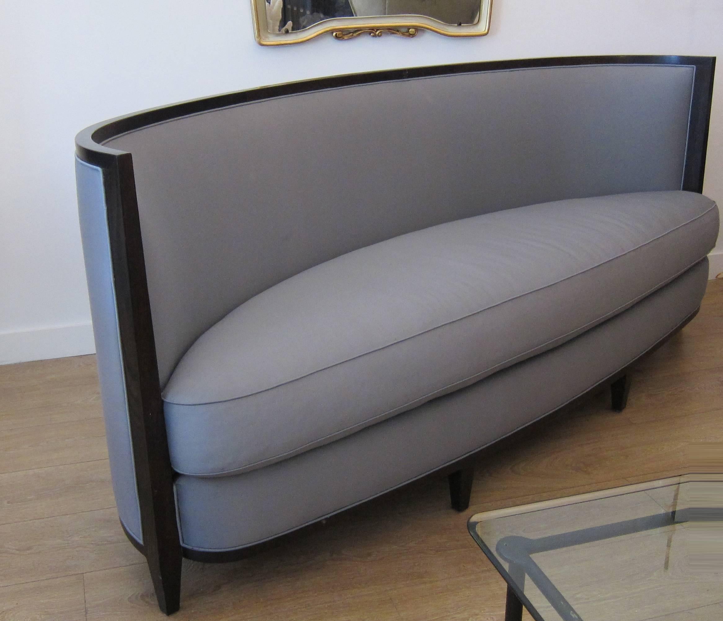 A large pair of crescent moon sofas by Andree Putman for Ralph Pucci. Solid stained oak frame with original blue satin upholstery.
Please feel free to call us for a full condition report.