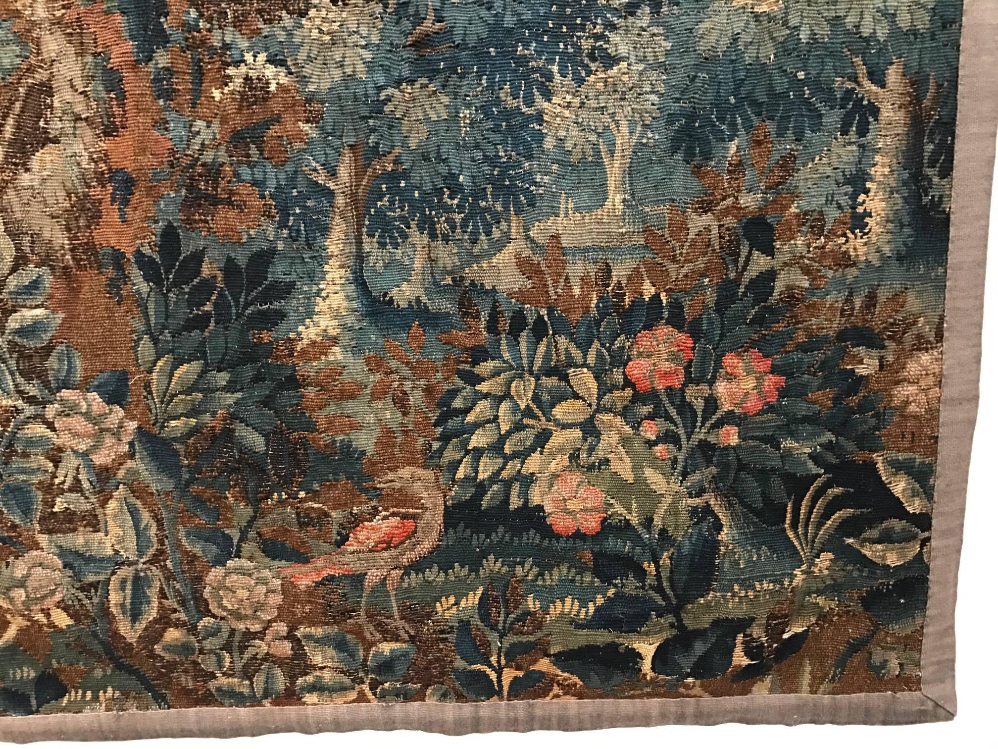 Tapestry panel, Franco-Flemish. Depicting a lush and wooded forest with flora and fauna receding to a distant village.