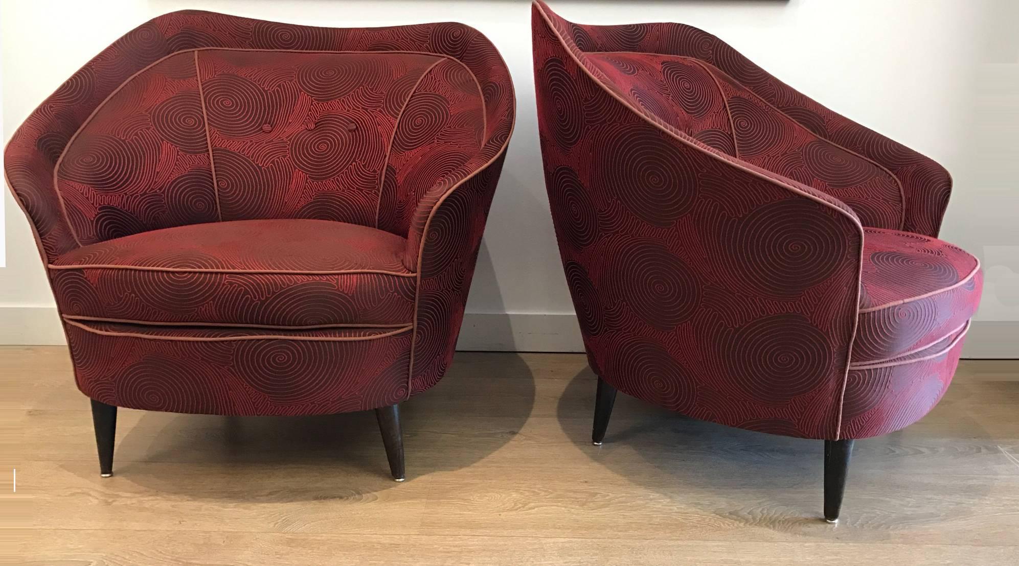 Pair of Italian Mid-Century lounge chairs. The overall design is reminiscent of the work of Gio Ponti for Casa e Giardino production. Newly upholstered, wooden conical legs.

For additional questions regarding this item, please click the