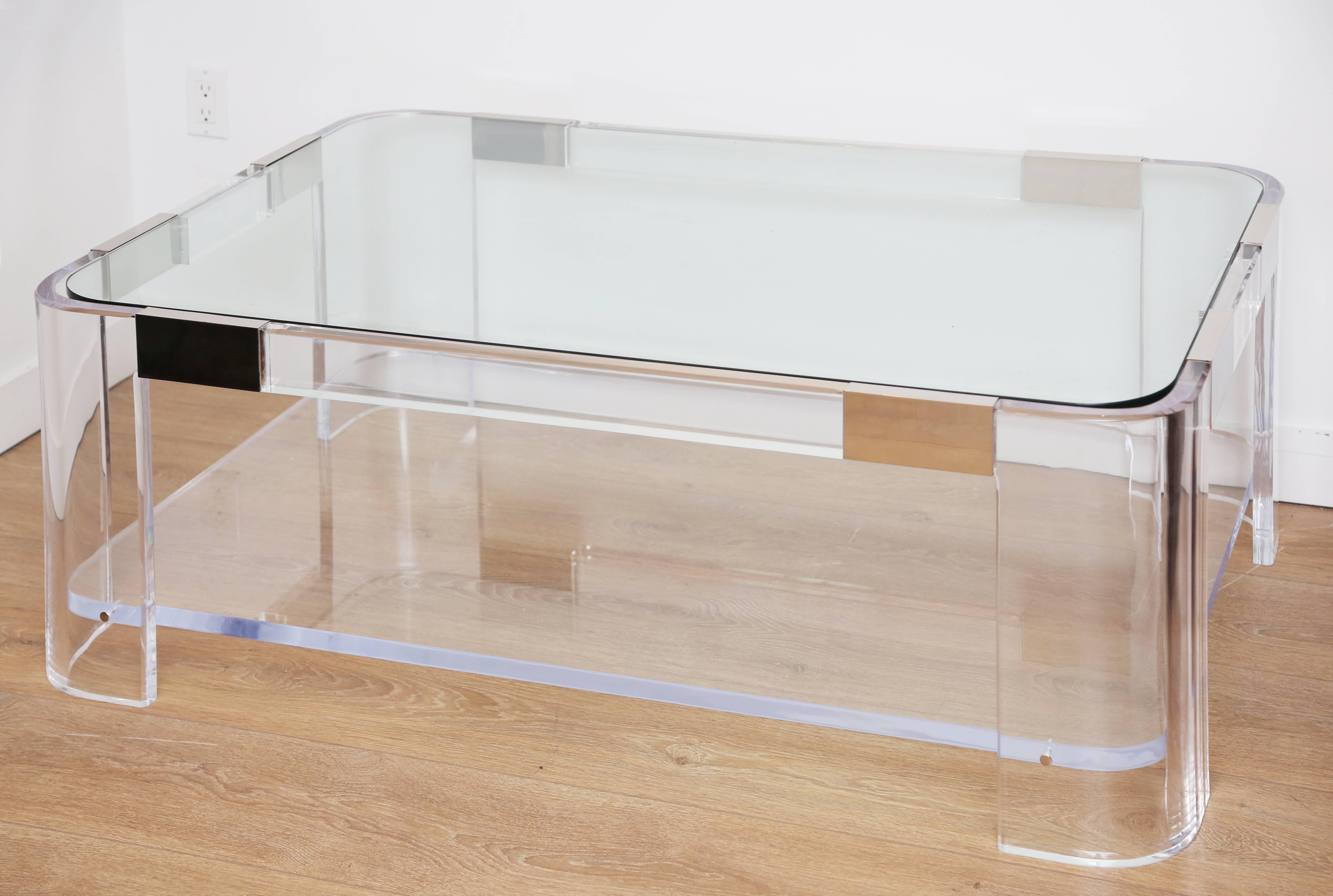 Large 1970s  two-tier lucite and polished nickel waterfall coffee table by Charles Hollis Jones. Lucite is thick and clear recently buffed to perfect condition. Top tier inset glass, bottom tier is made of thick lucite.