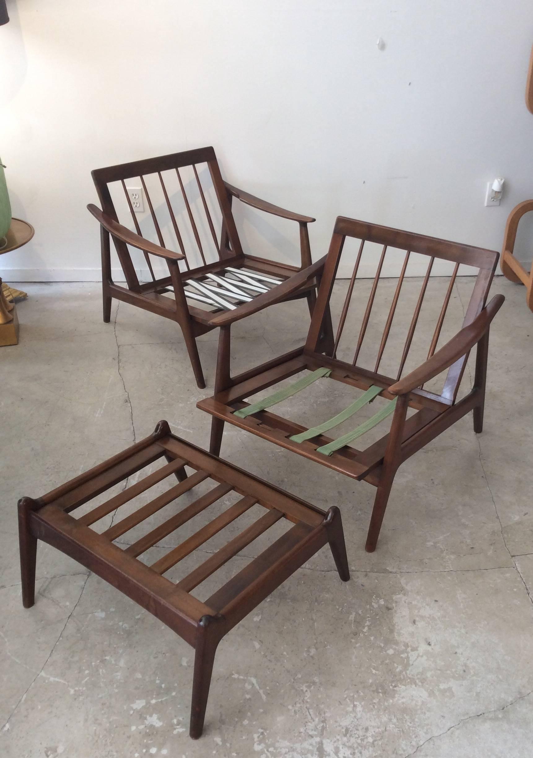 These chairs are the epitome of Danish Mid-Century style. Constructed of walnut with a rich stained finish and loose foam upholstered cushions for back and seat support. Look in the photos for the nice connections tween legs and arms. The backs have
