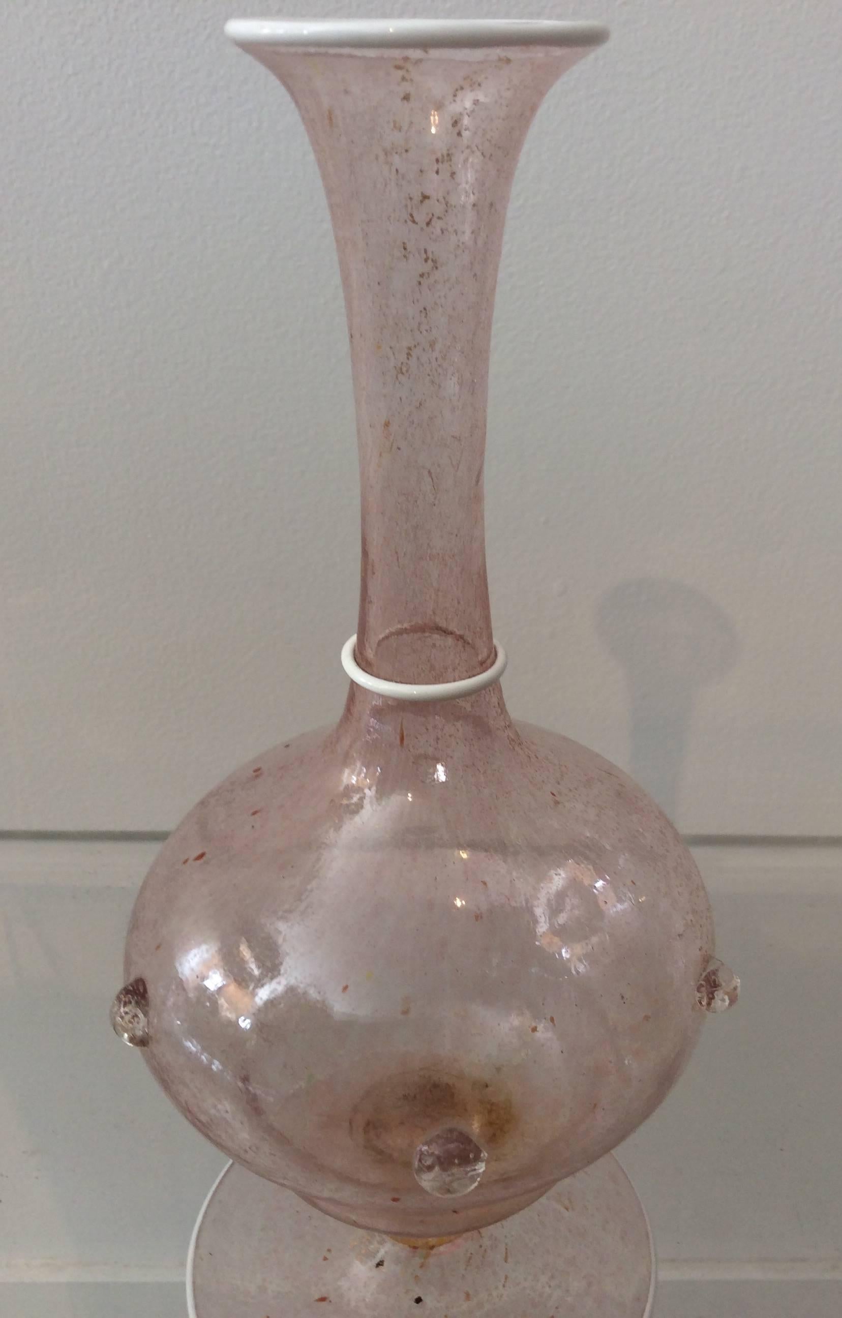 You are looking at a vintage glass vase by Salviati made in Murano Italy. The glass walls are very delicately handblown with a white rim accent at three different places on the vase. The color is pretty true to photos, kind of hard to describe.
