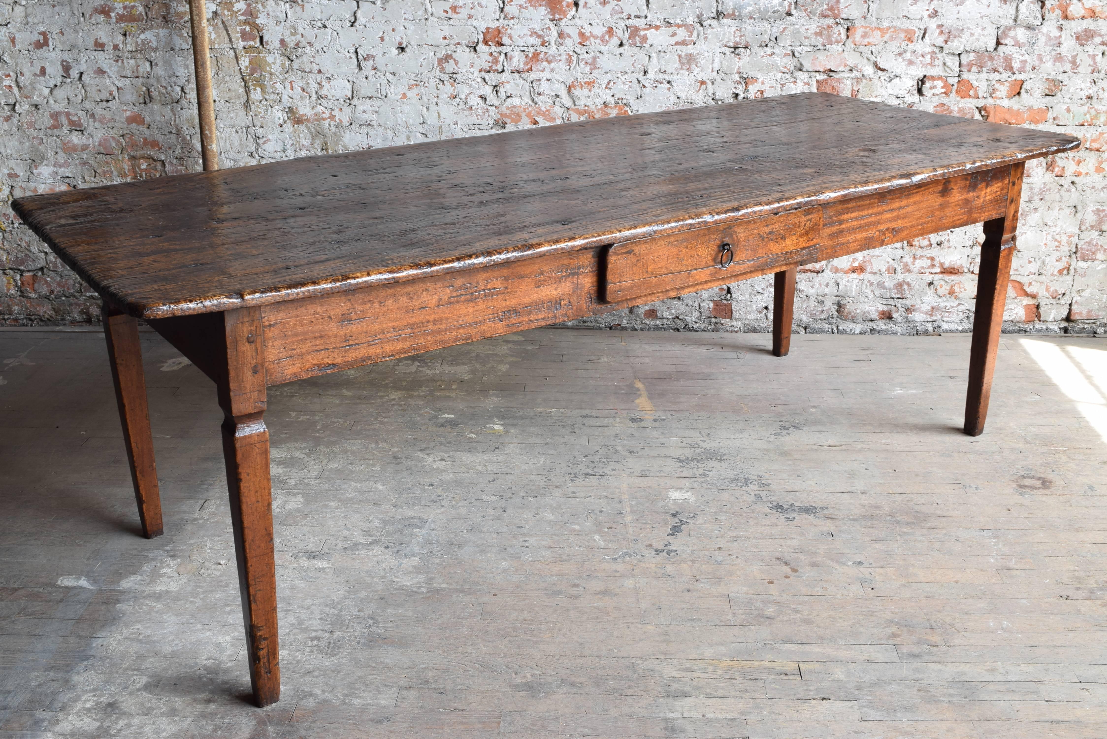 From the early 19th century, the rectangular top above a conforming case housing one drawer with a wrought iron pull, raised on square tapering legs.