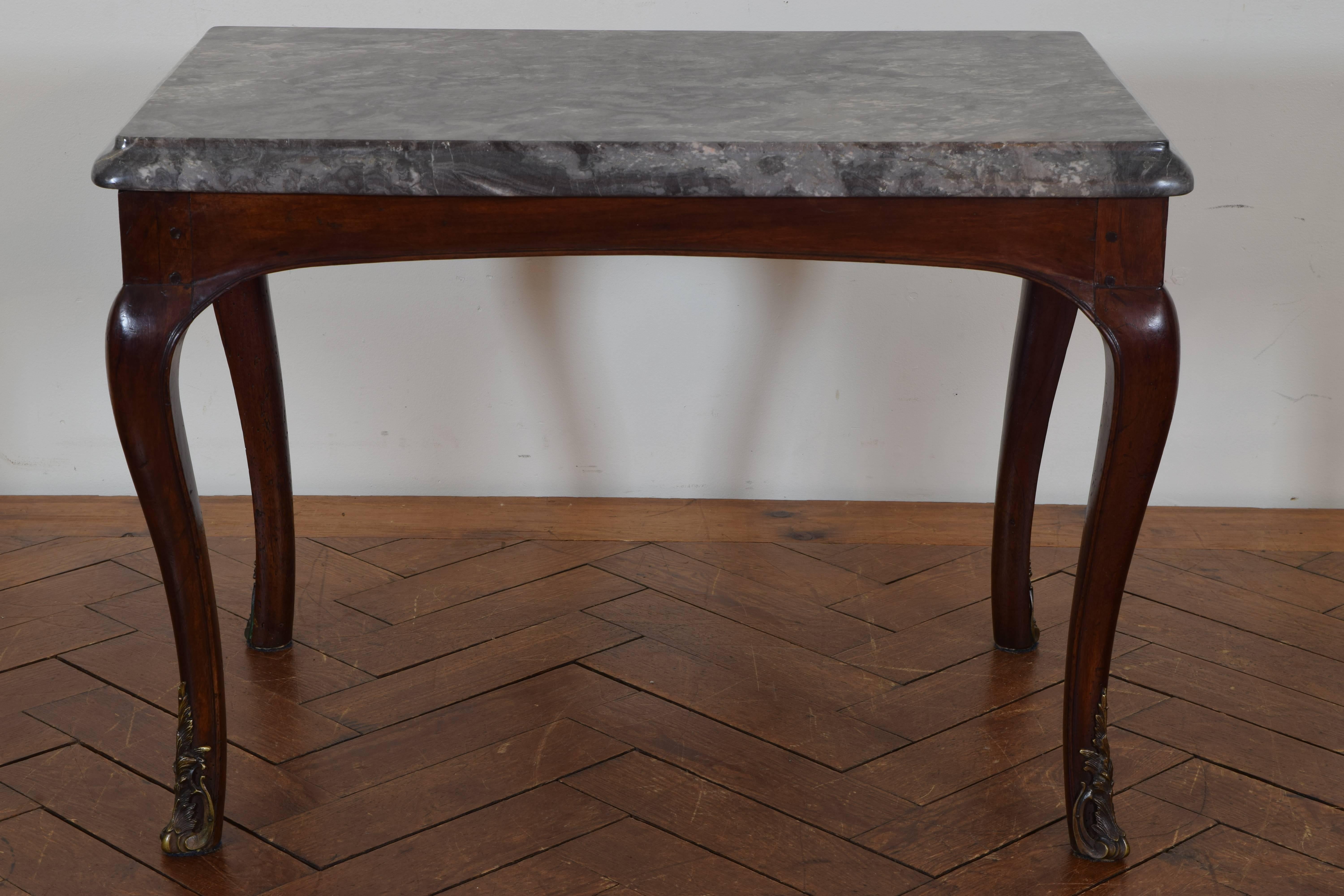 The thick marble-top with a rounded molded edge atop a frame with shaped apron and cabriole legs mounted with bronze sabots.