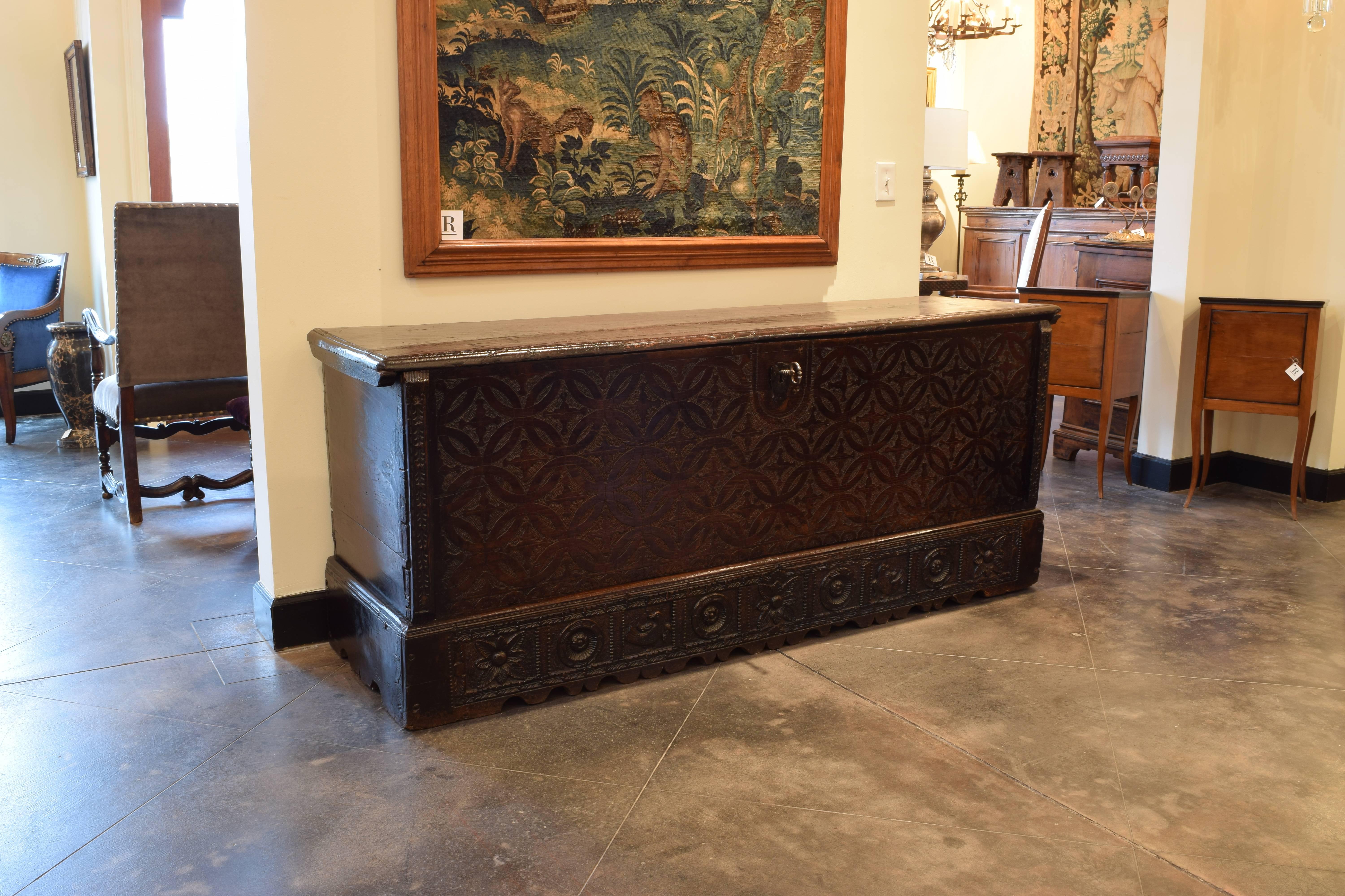 Walnut trunk with punched and carved Gothic details including florals, birds, and patterns.