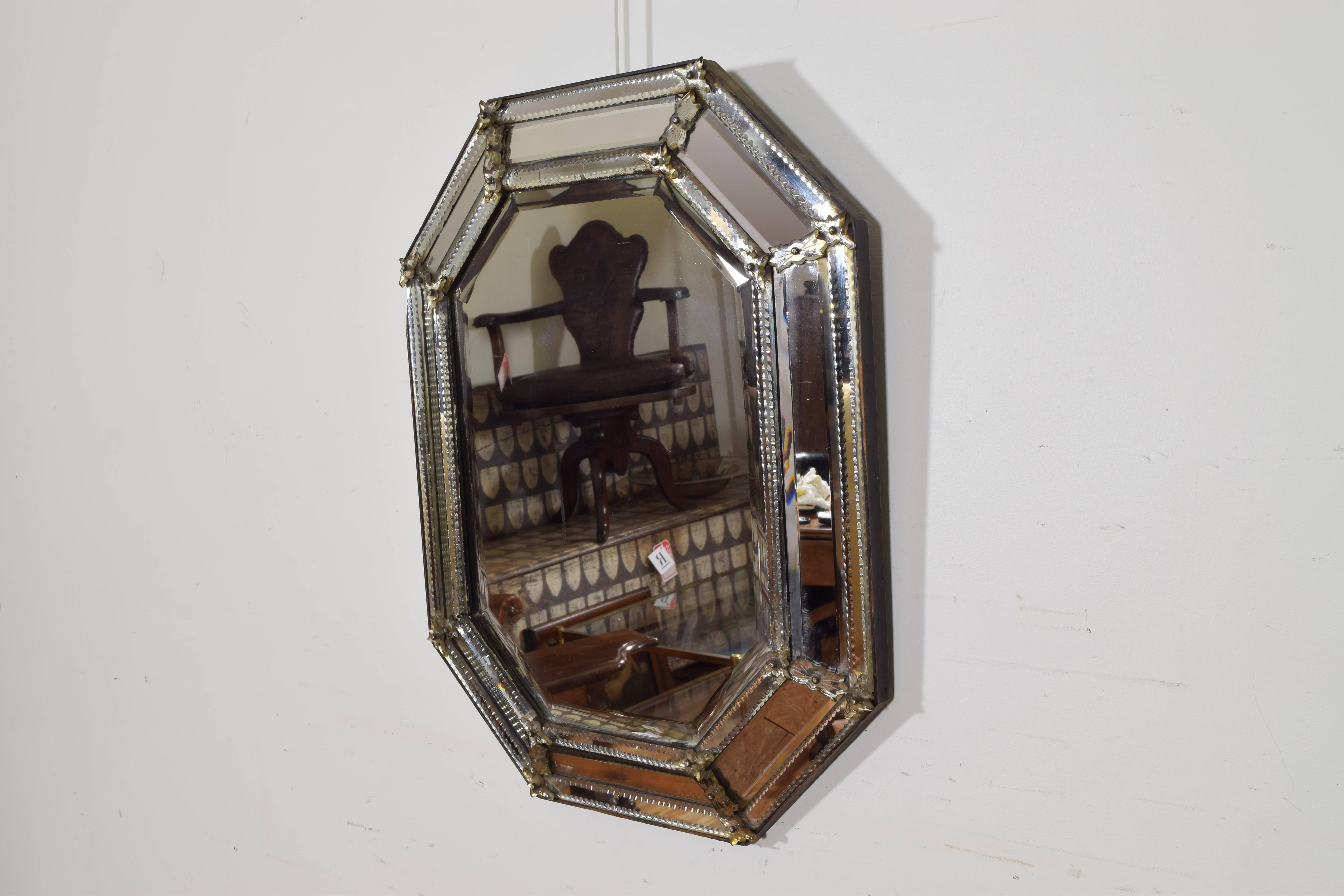 Of octagonal form with a raised center section and etched glass trim, retaining antique mirror plates.