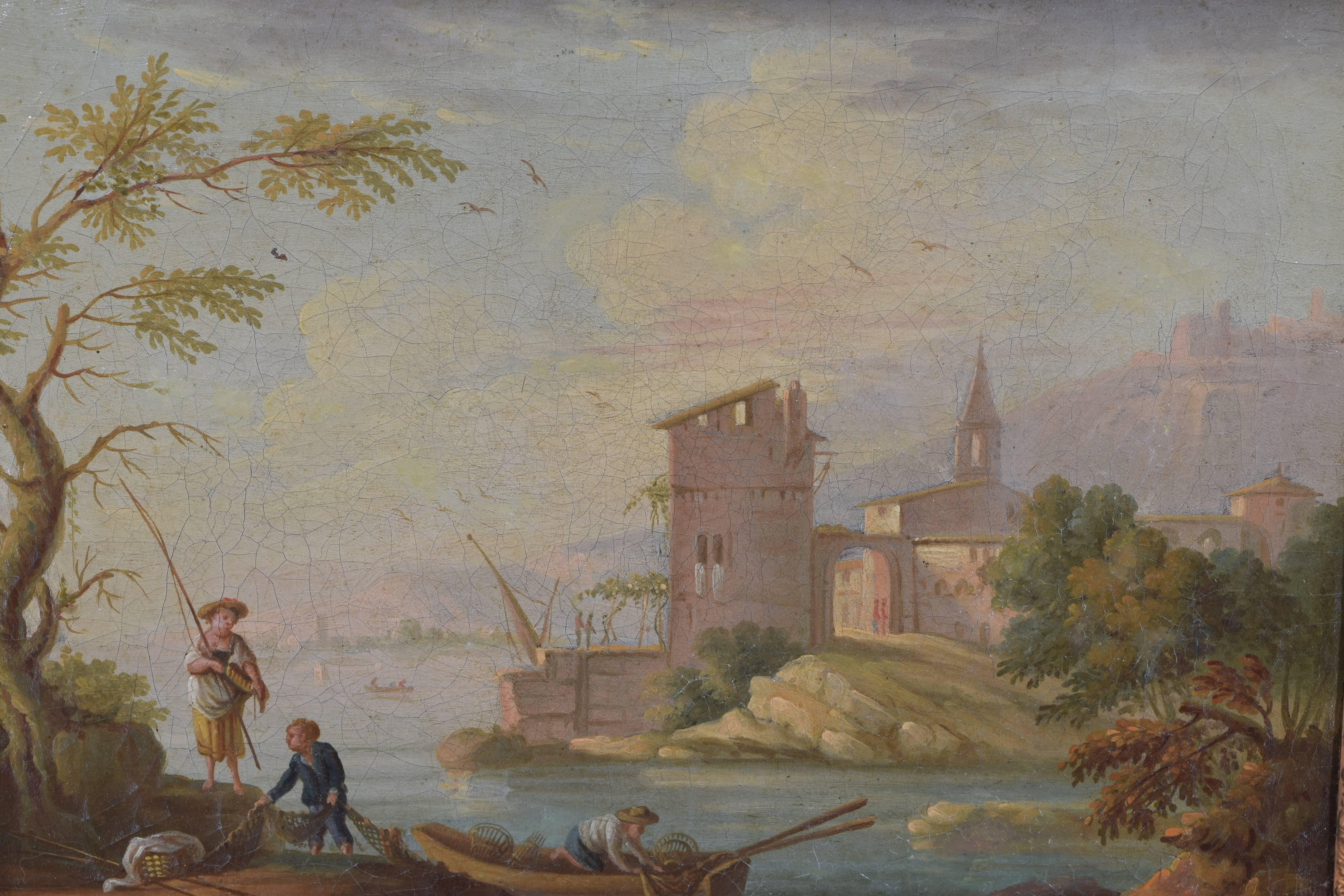 The beautifully painted scene with a village in the background and a fishing party in the foreground, in a period giltwood frame, second quarter of the 19th century.