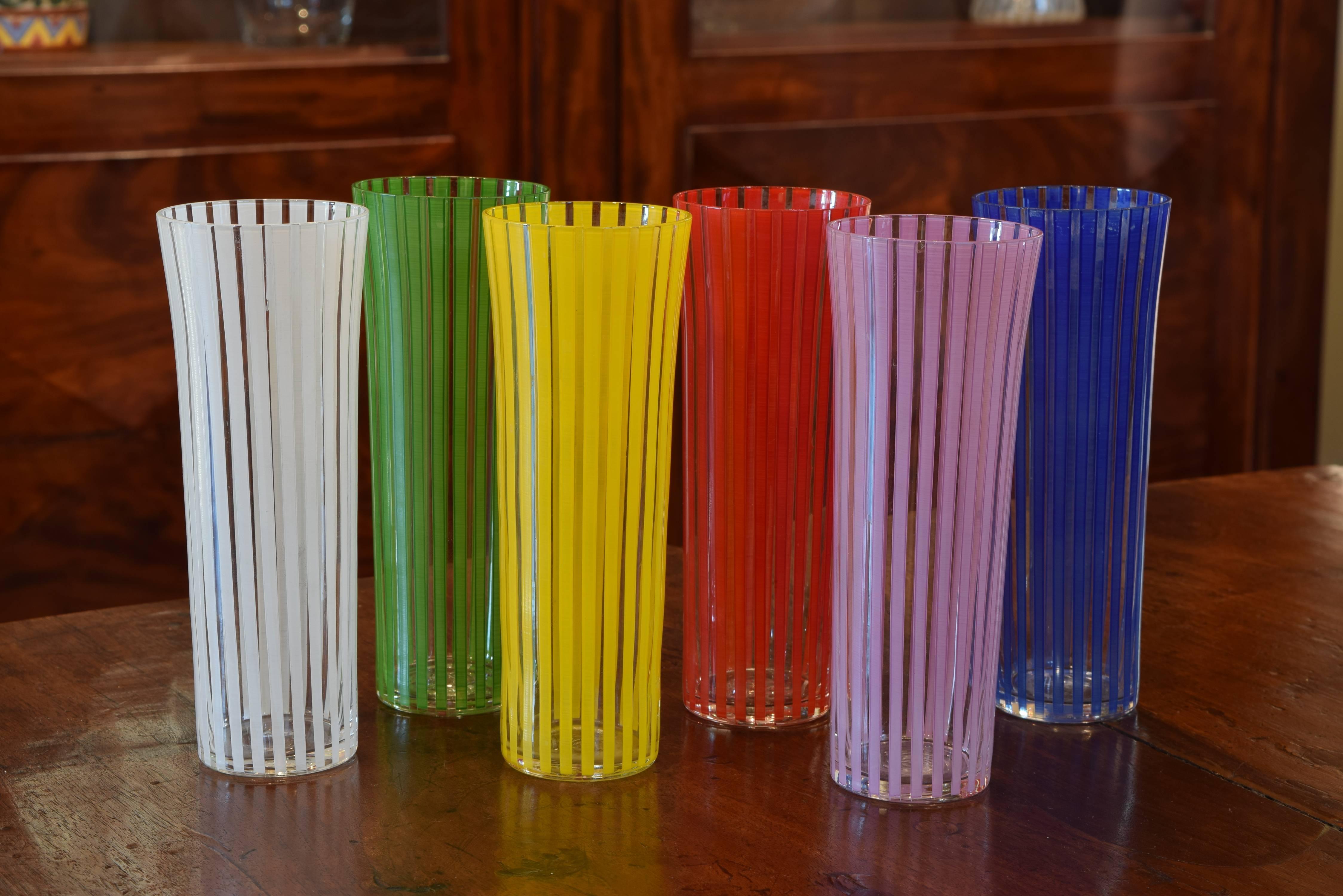 Handblown glasses slightly flaring at tops, the vertical stripes are etched and painted, in mint condition.