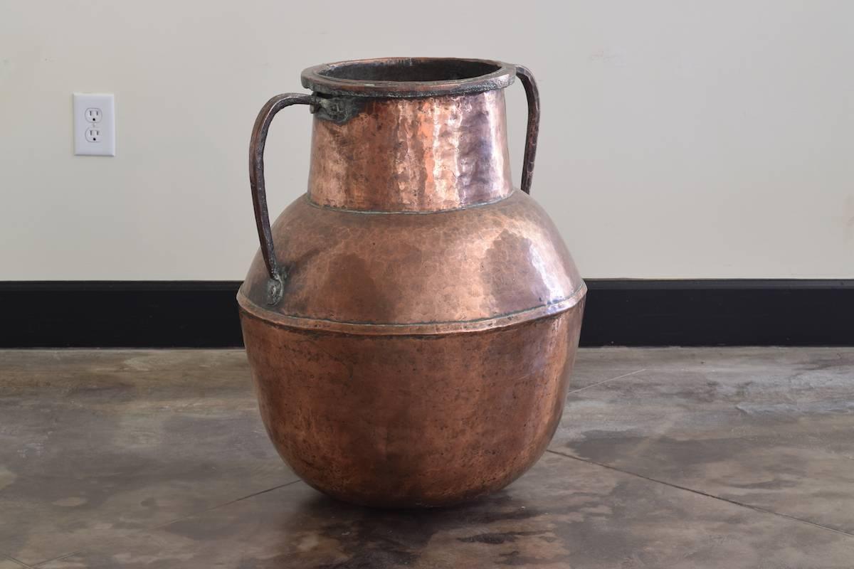 Hand-forged, hammered and well-patinated copper urn.