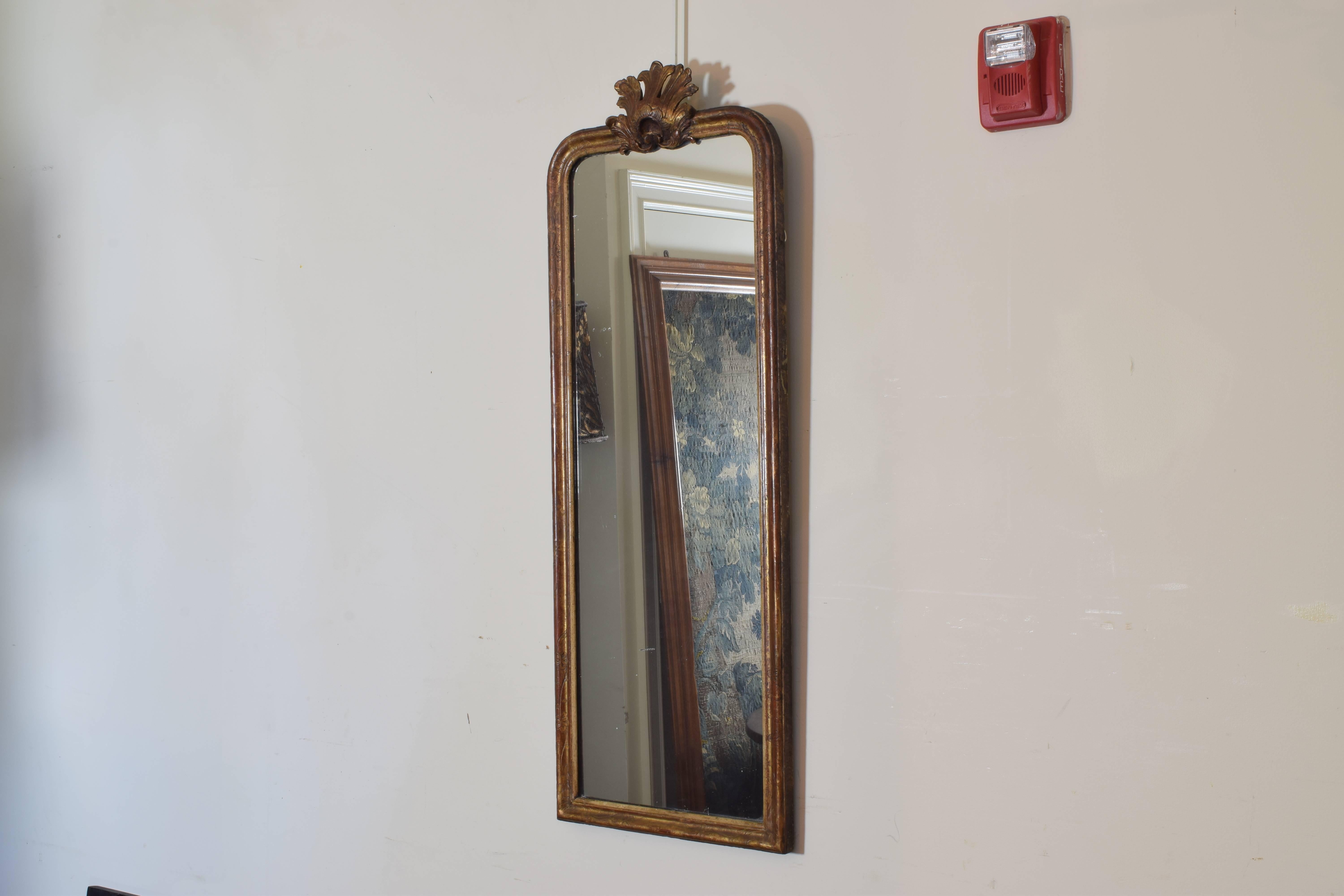 The slender mirror with a centered shell carving at the top.