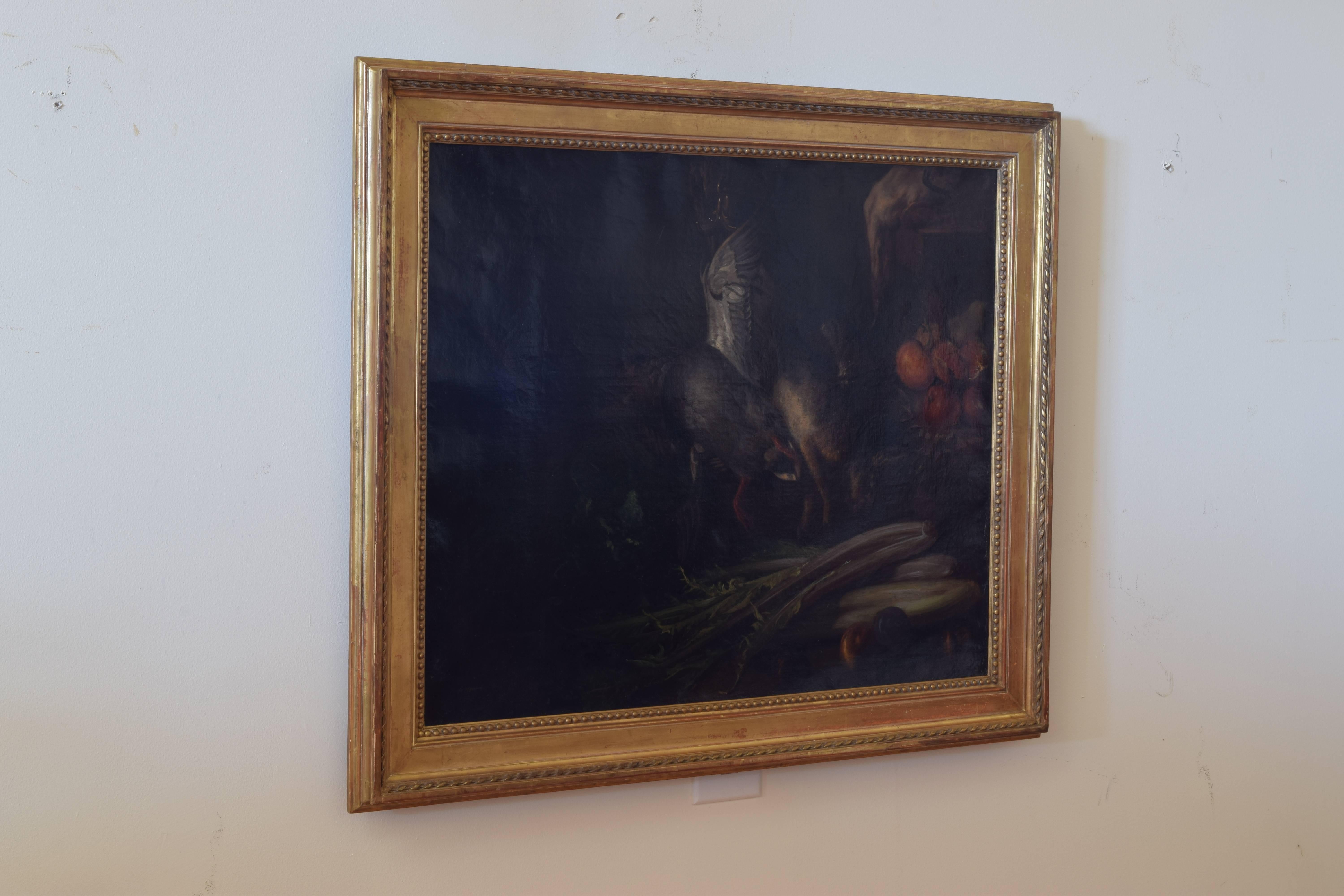 The painting depicting a still life with a hare, fowl, fruits, and leeks, set in a period giltwood frame from the second quarter of the 19th century, initials AP on back of canvas.