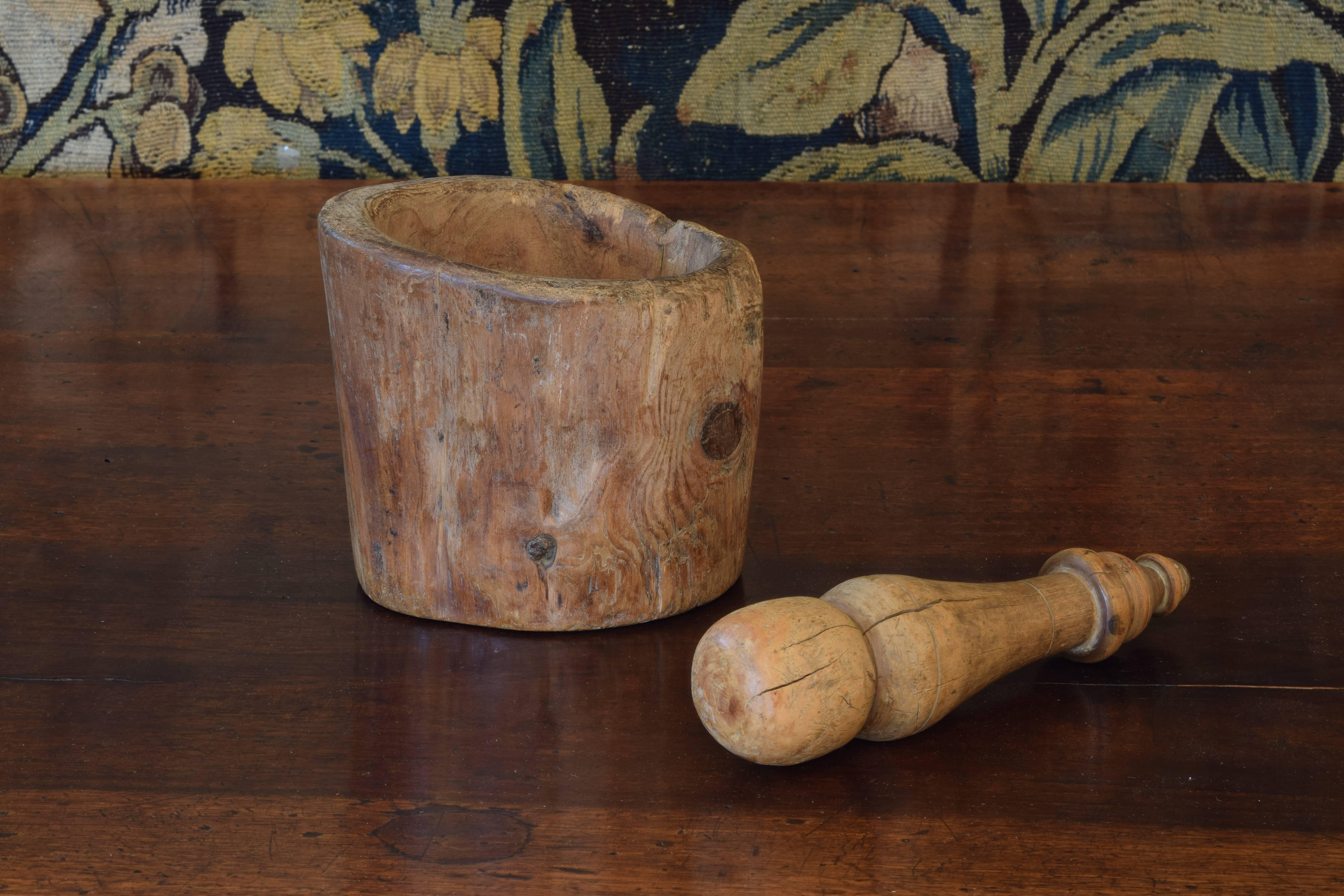 The hollowed branch carved to form the mortar, length of the turned pestle is 8 inches, both made of boxwood.