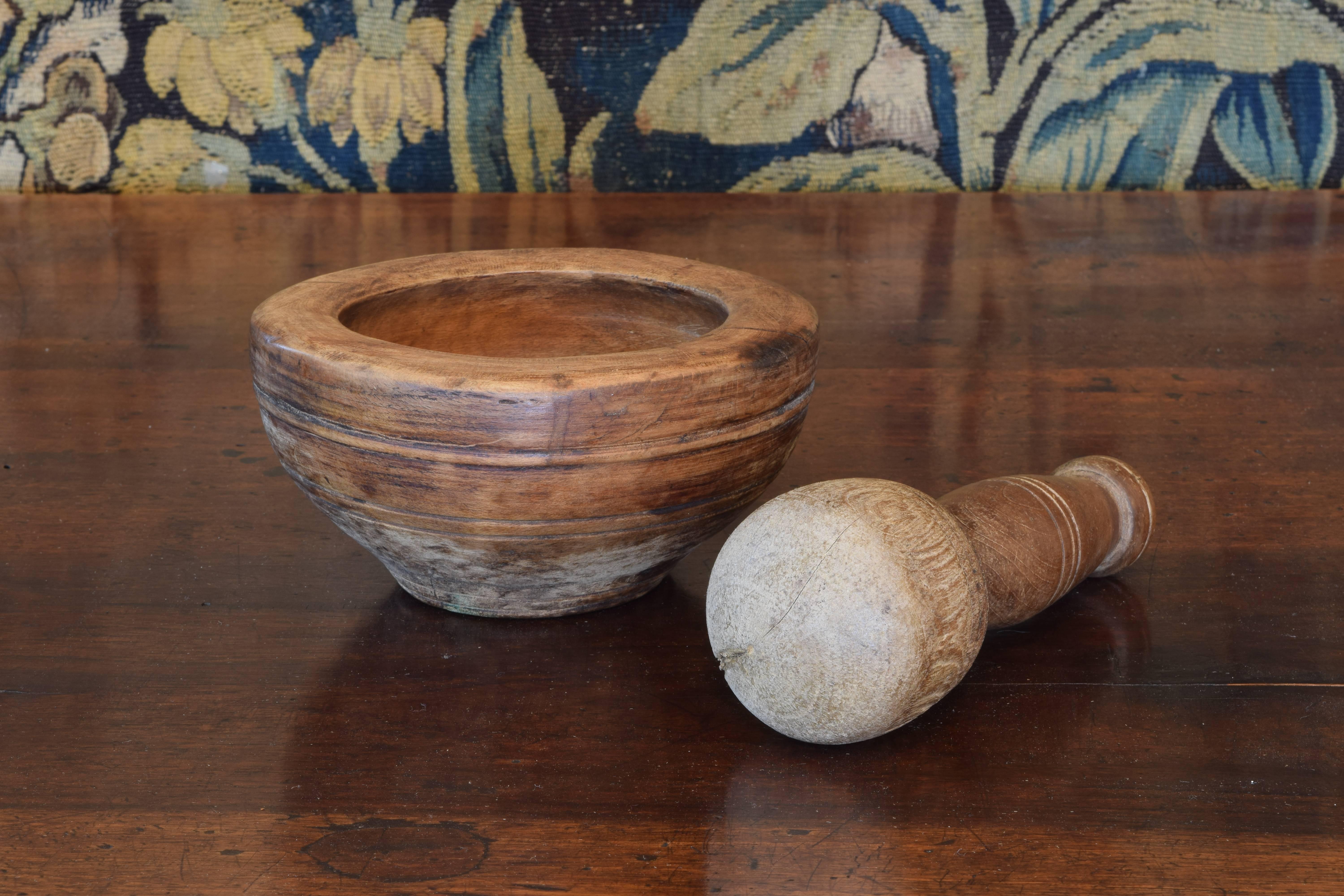 Both the mortar and pestle turned on a lathe and featuring string line decoration.