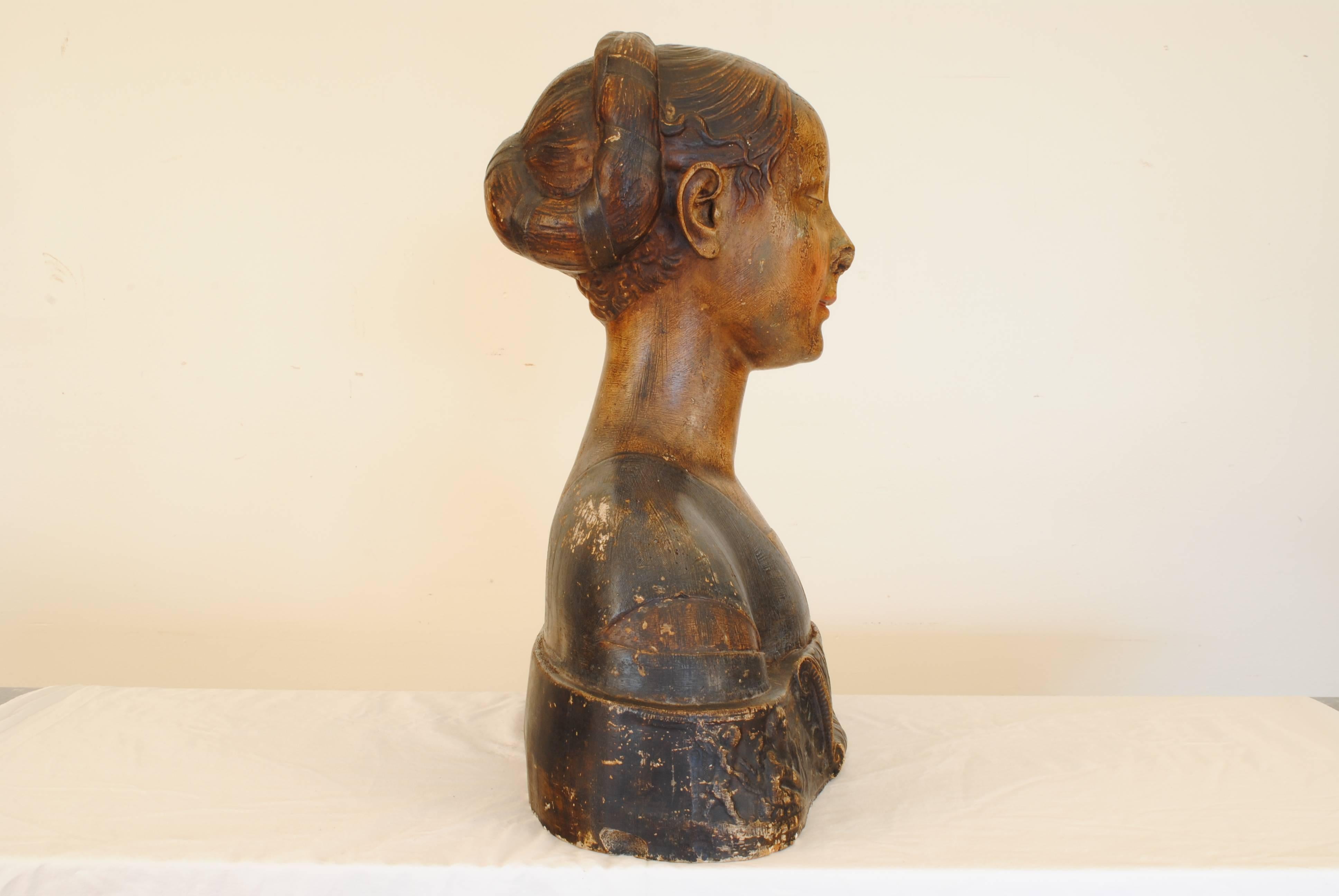 Having a contemplative downward gaze, hair back and with a blue tunic atop a scroll and neoclassically decorated plinth base, finished on the reverse.