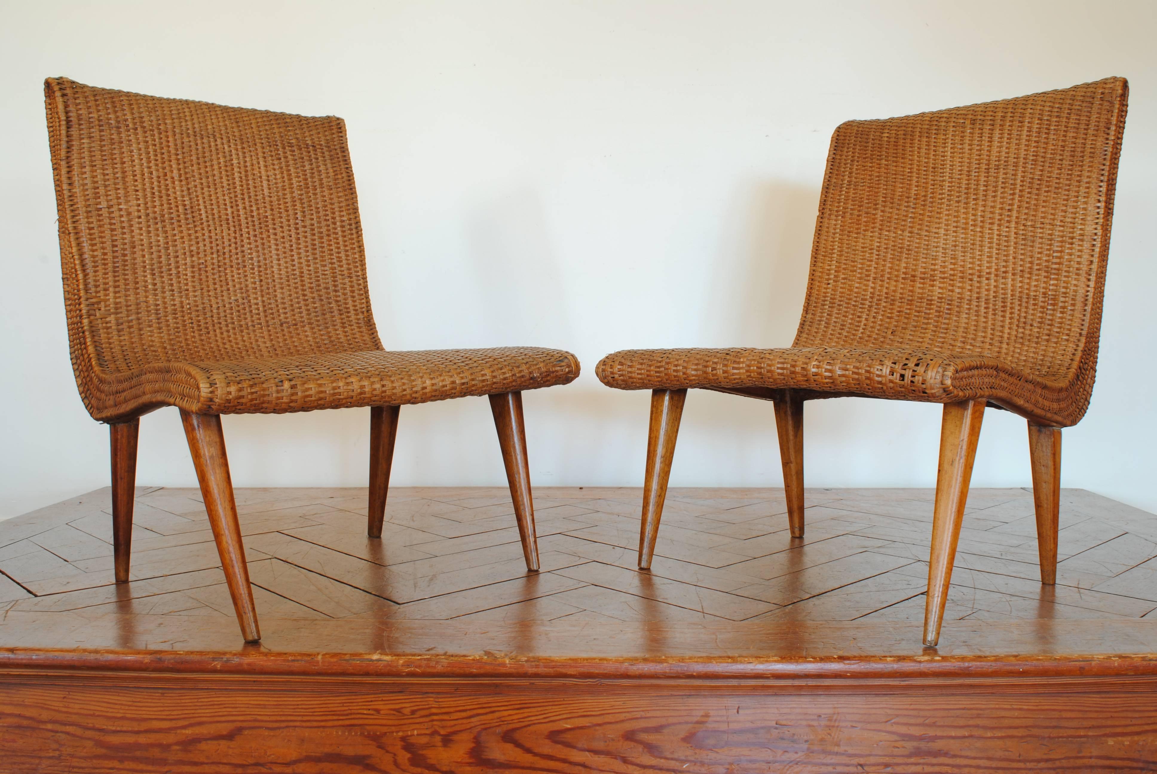 Upholstered in original rattan and raised on four tapering legs, second half of the 20th century.