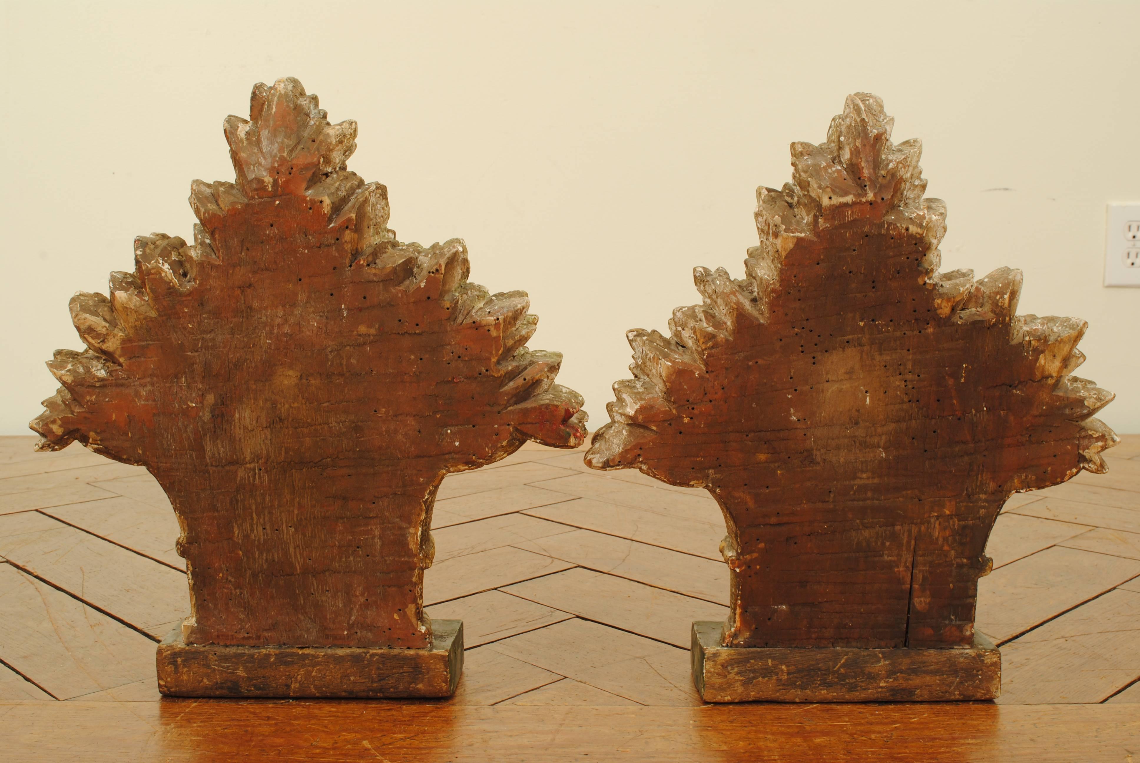 Pair of decoratively carved giltwood flower baskets. Mounted on faux marble painted bases.