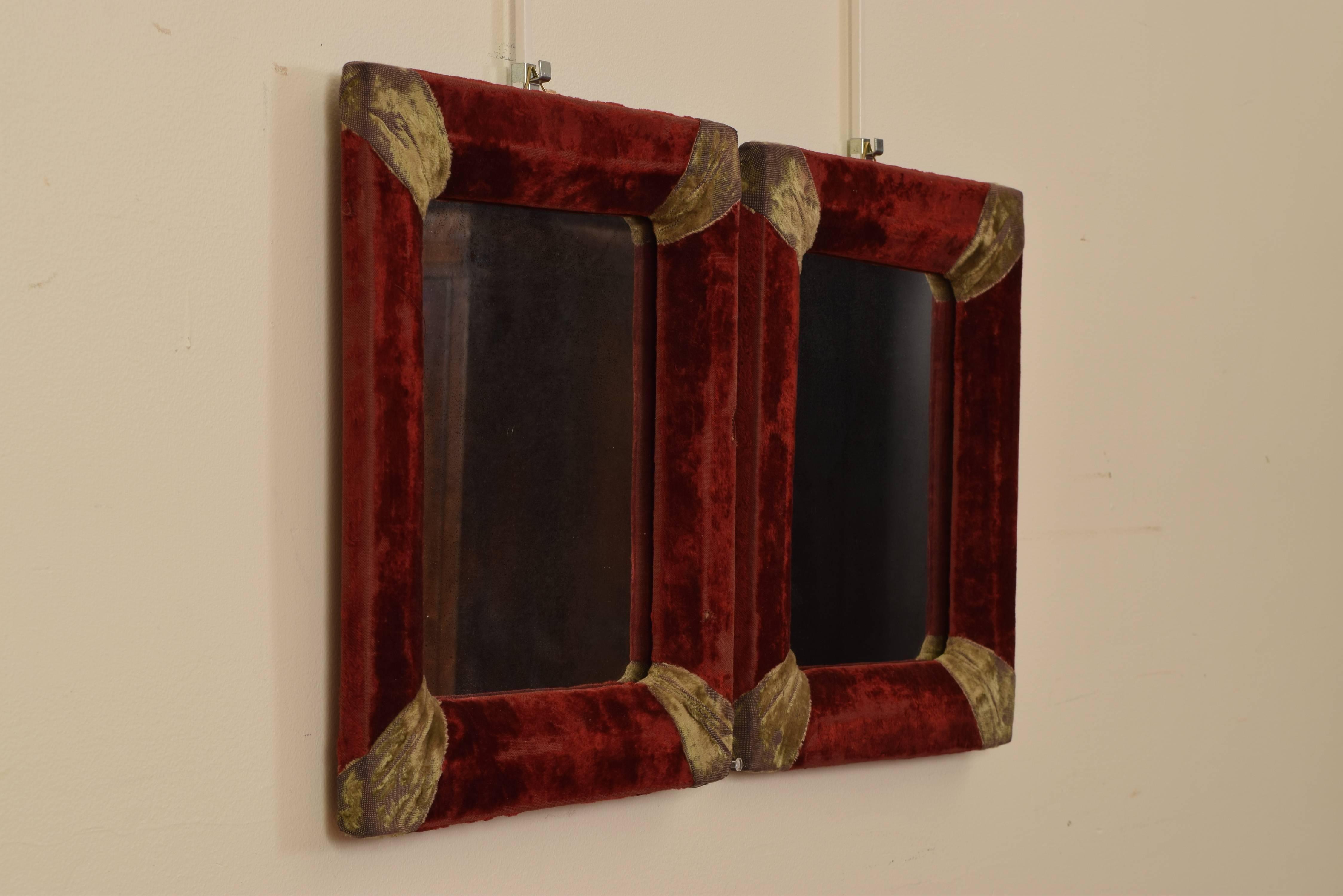 Pair of frames with beveled edges covered in reddish maroon velvet, the corners covered in green velvet, having later 
