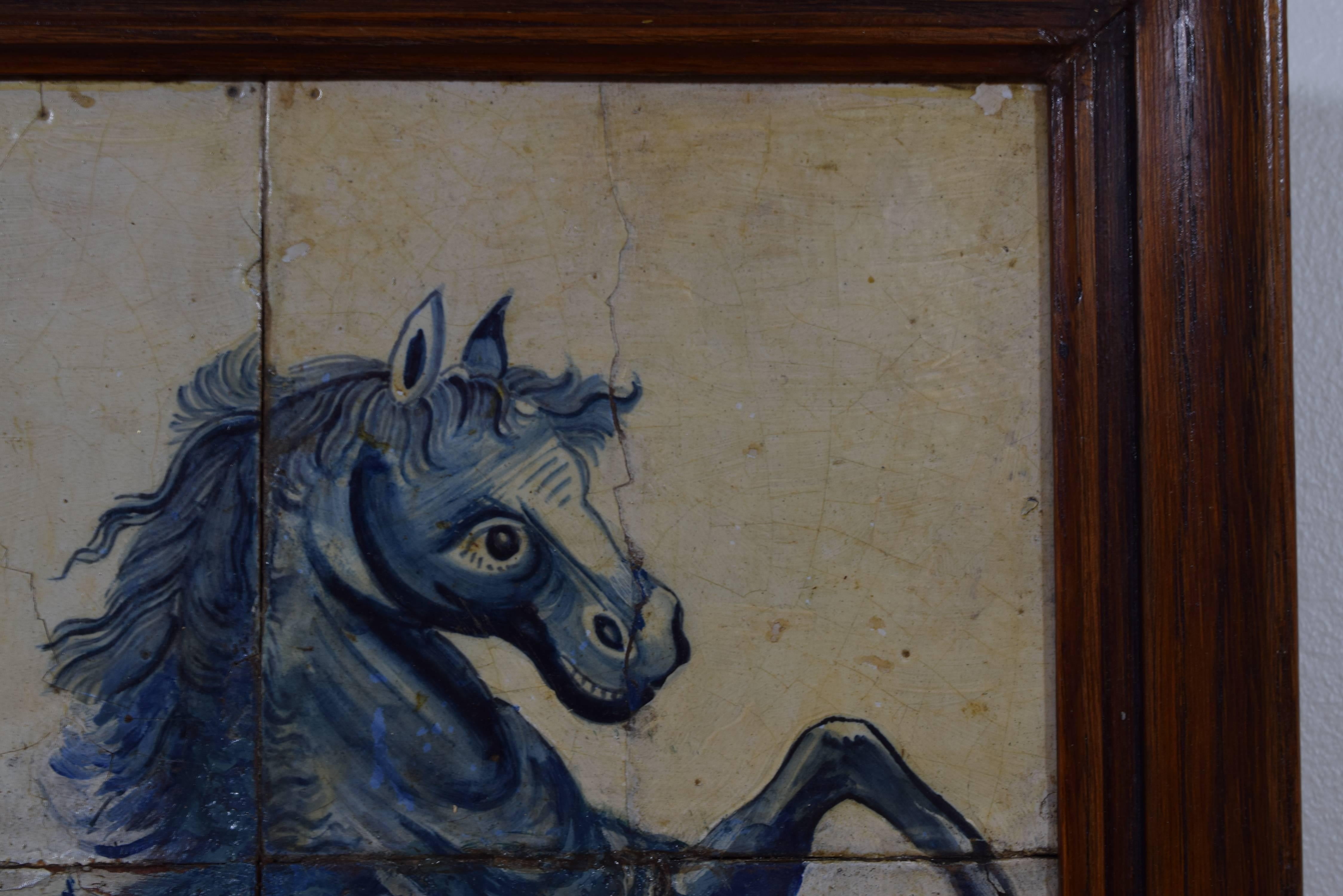 Six tiles painted with a rearing horse in a foliate background, in a later frame.