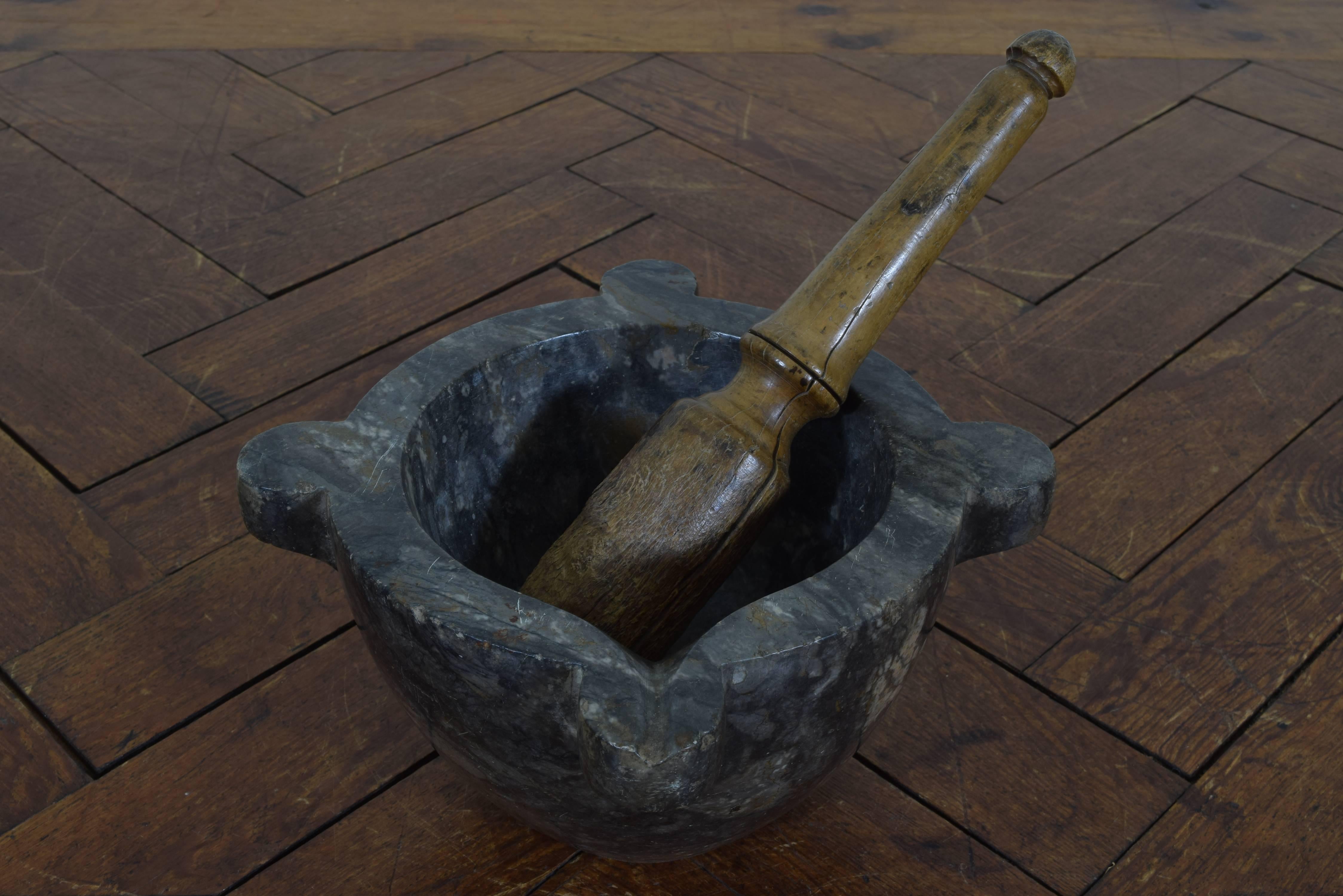 Beautifully worn and patinated marble mortar with a pouring funnel on one corner, length of pestle is 14