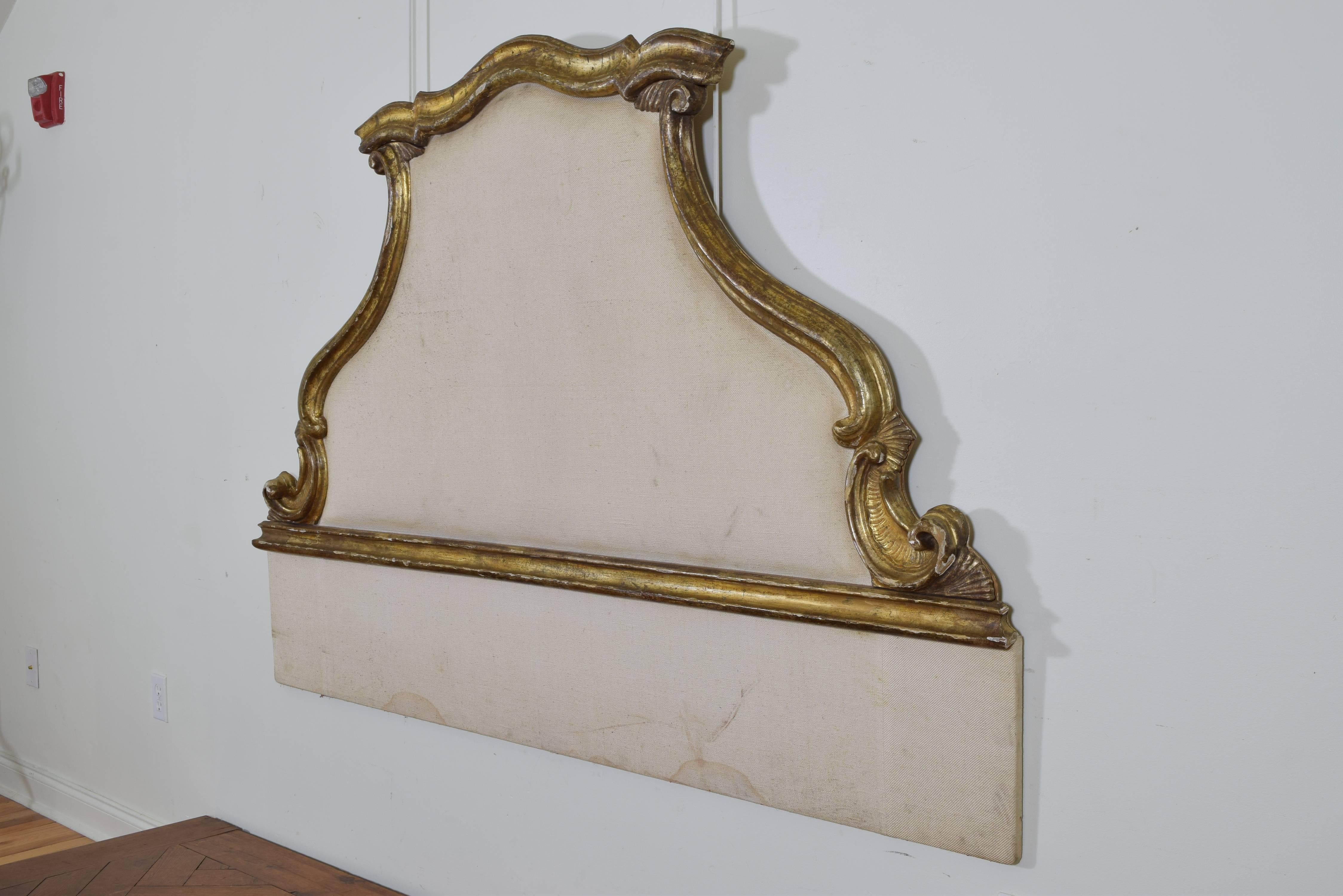 Partially composed of antique elements the giltwood sections mounted from reverse on a later backing, the front upholstered.