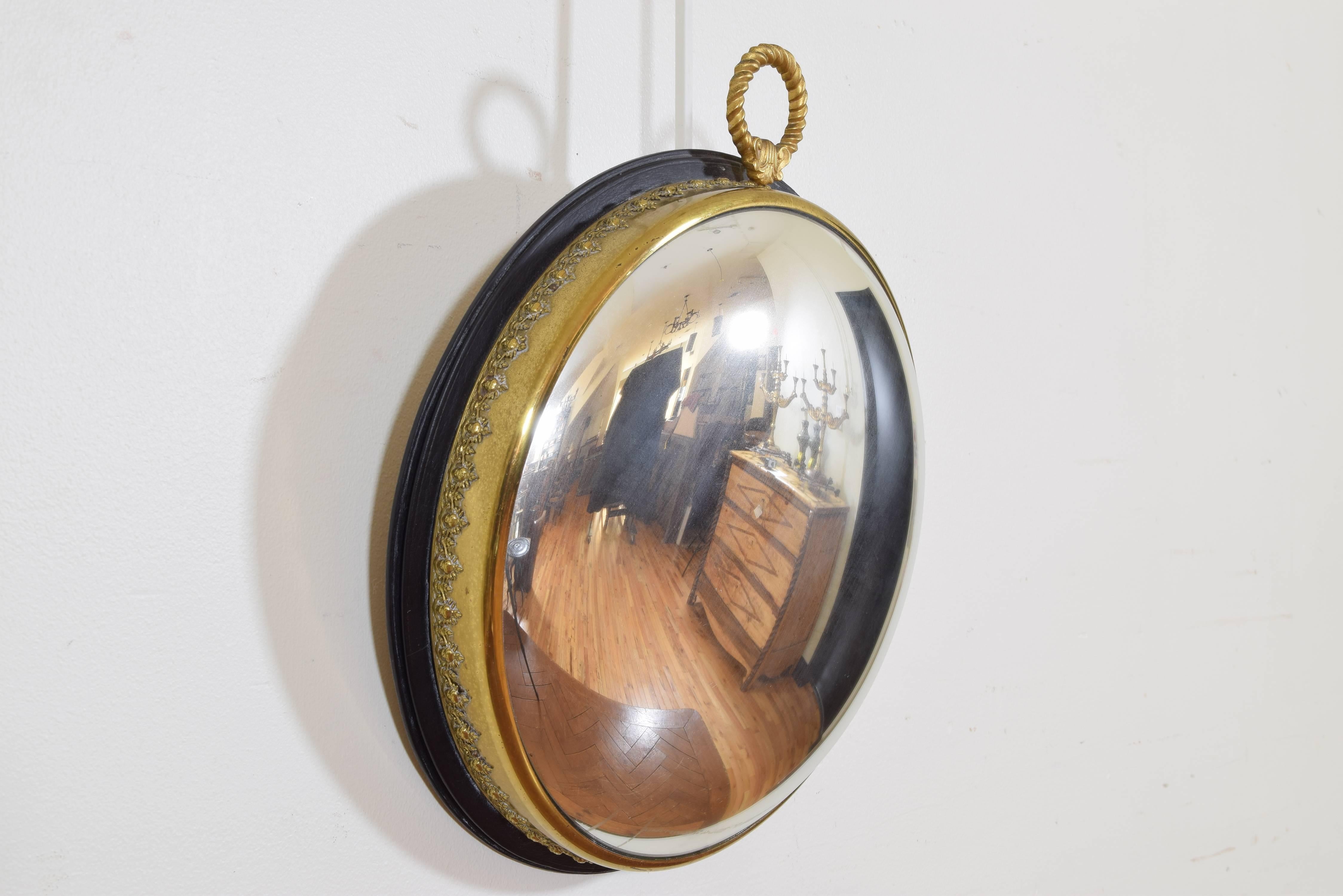 Made to resemble a pocket watch and having a cast brass gallery, retaining original convex mirrorplate.