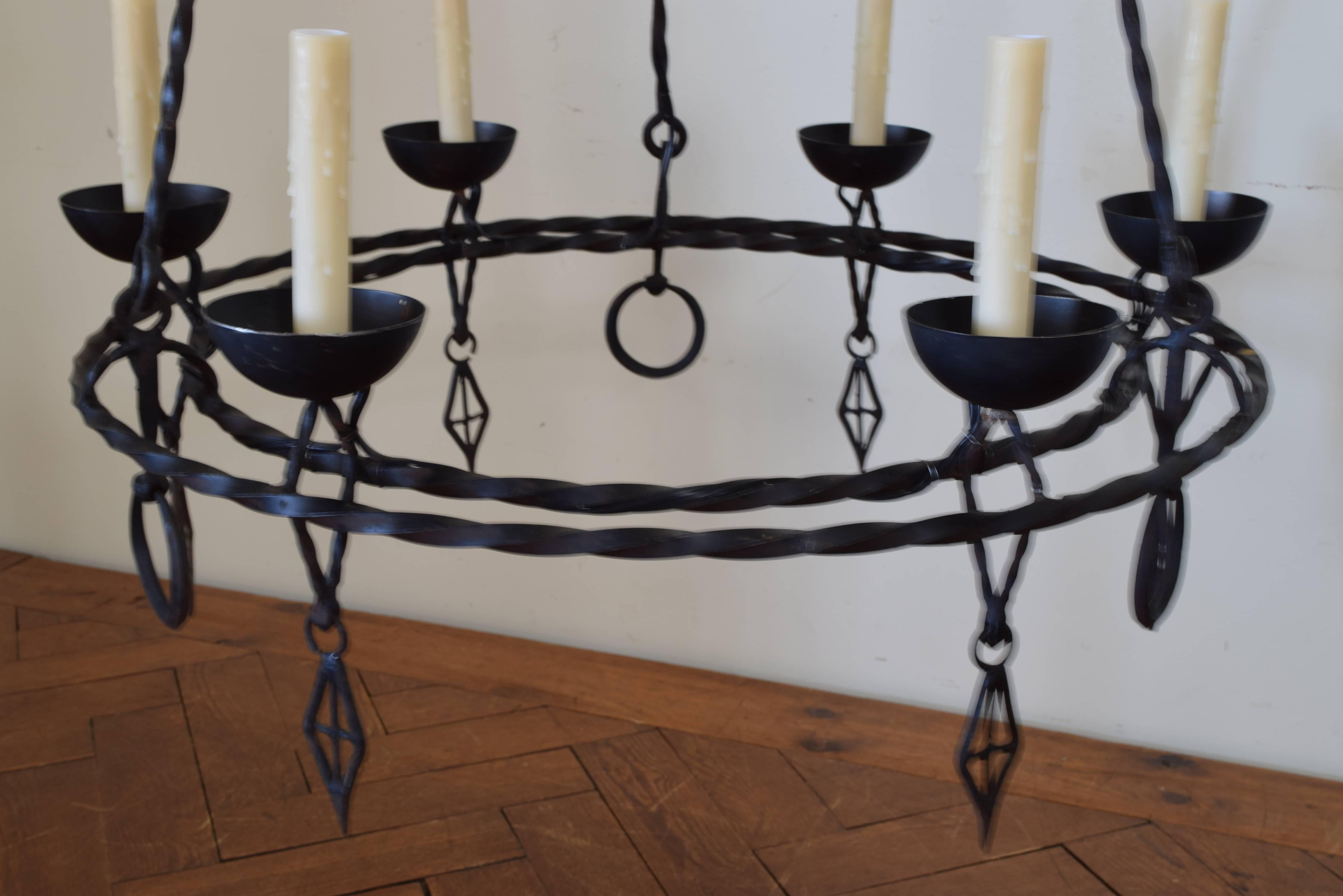 Hanging from original rods and comprised of twisting iron, six lights, UL wired.