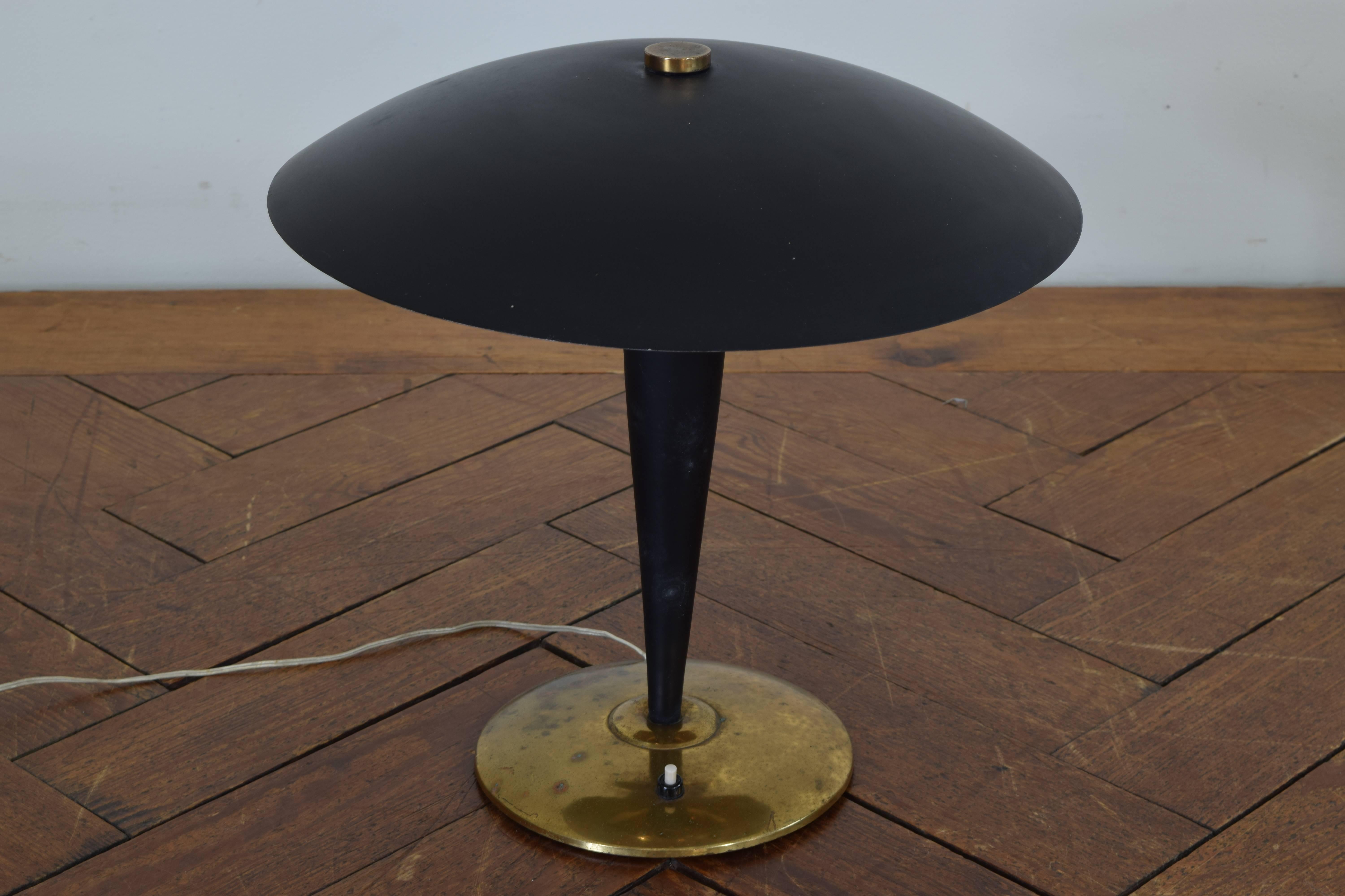Having a hooded round shade and raised on a tapering standard atop a circular base.