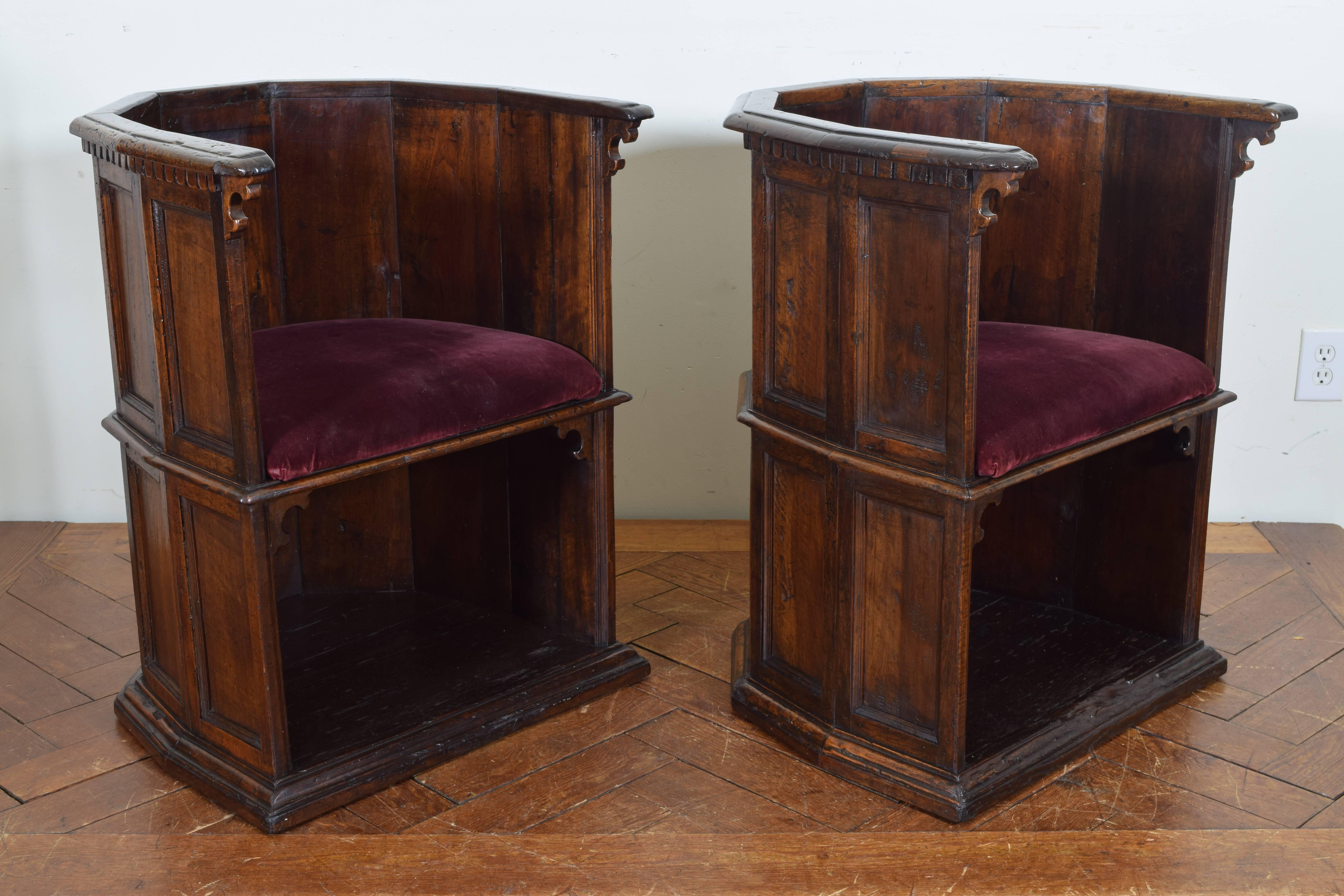 Pair of Italian Late Renaissance walnut chairs of hexagonal form with paneled exterior and carved armrests, the seats above platforms, formerly sold by French & Co., New York.  Scranni plural of Scranno, borrowing from Lombardic skranna (“bench”). 