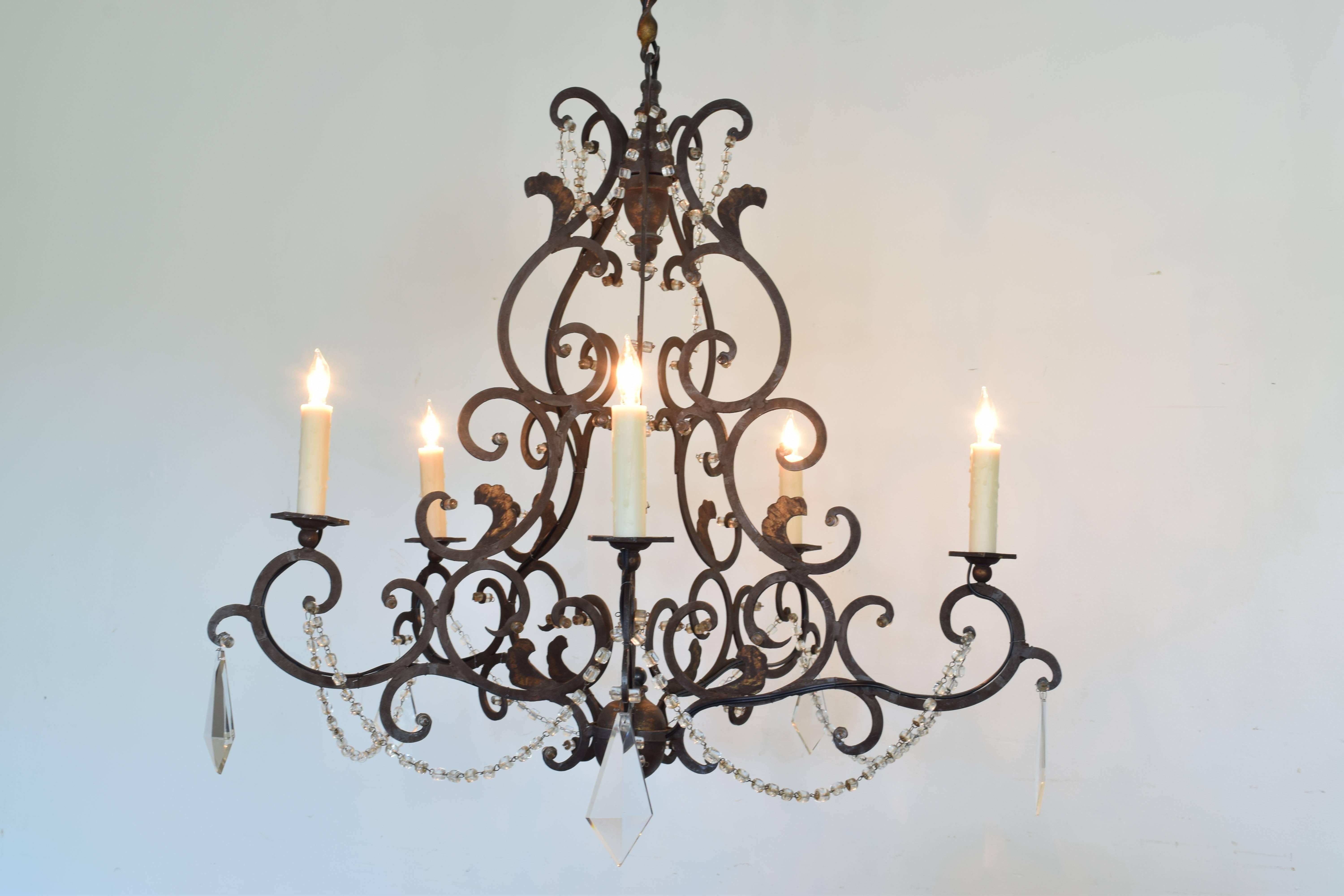 Italian wrought and gilt iron five-light chandelier in the Rococo style with scrolling frame and hexagonal bobeches.