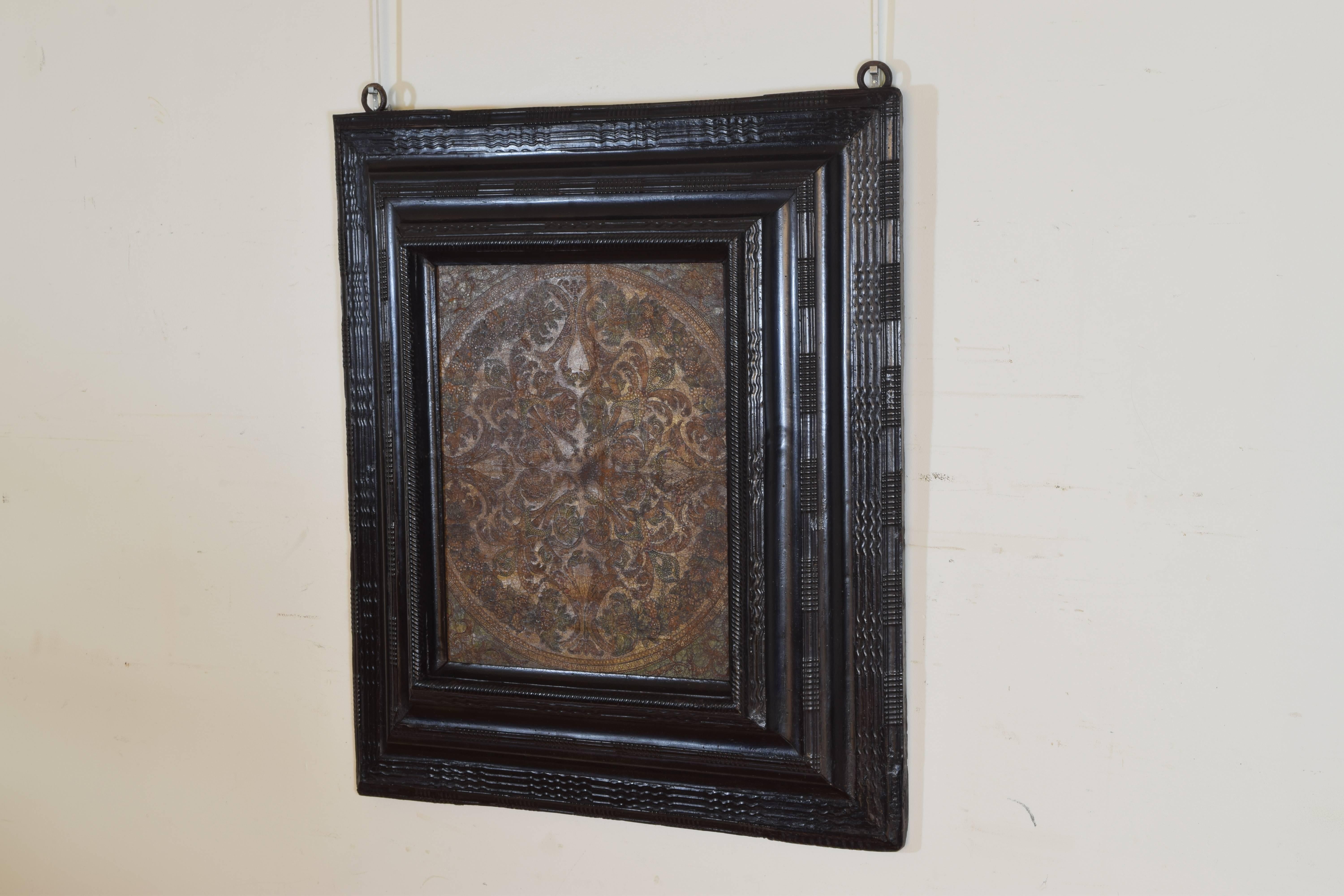The Italian, 18th-19th century panel polychrome painted and tooled in a 17th century guilloche ebonized frame.