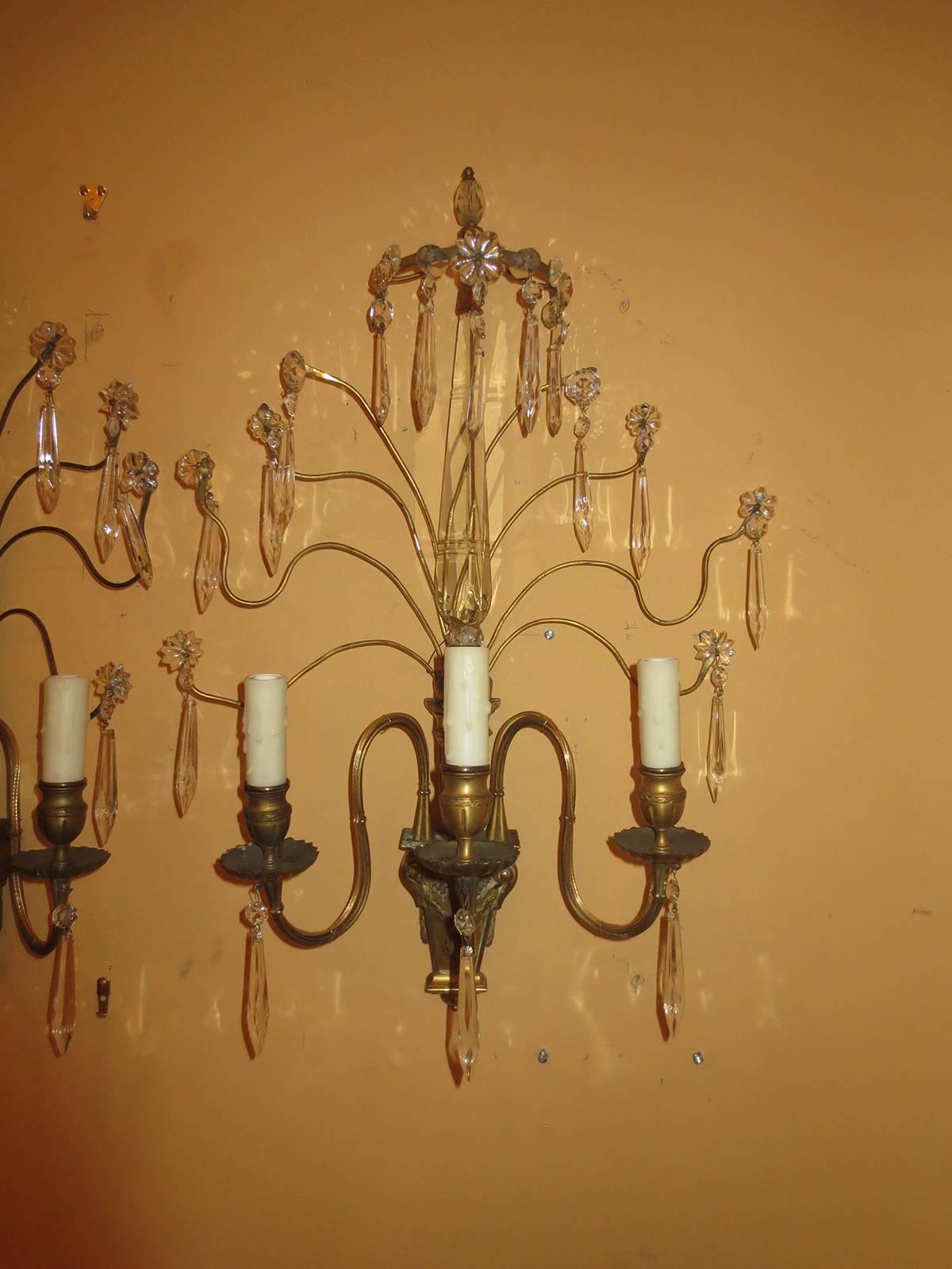 Pair of early 20th century bronze and crystal sconces.